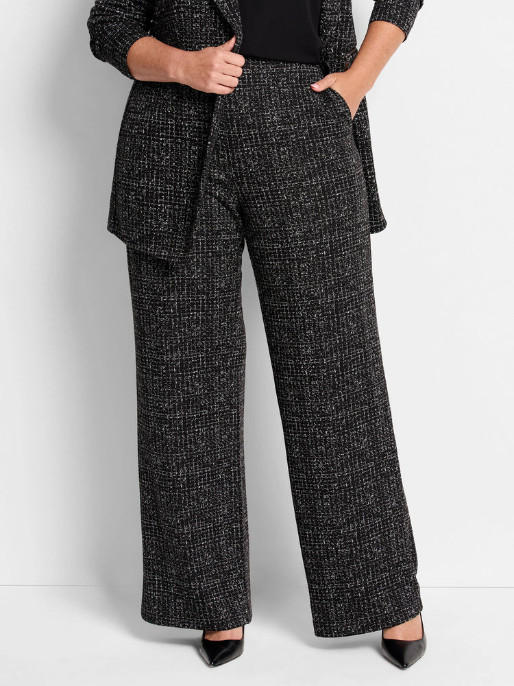 Black wide-leg pants with a small white grid pattern. Model wears black shoes.