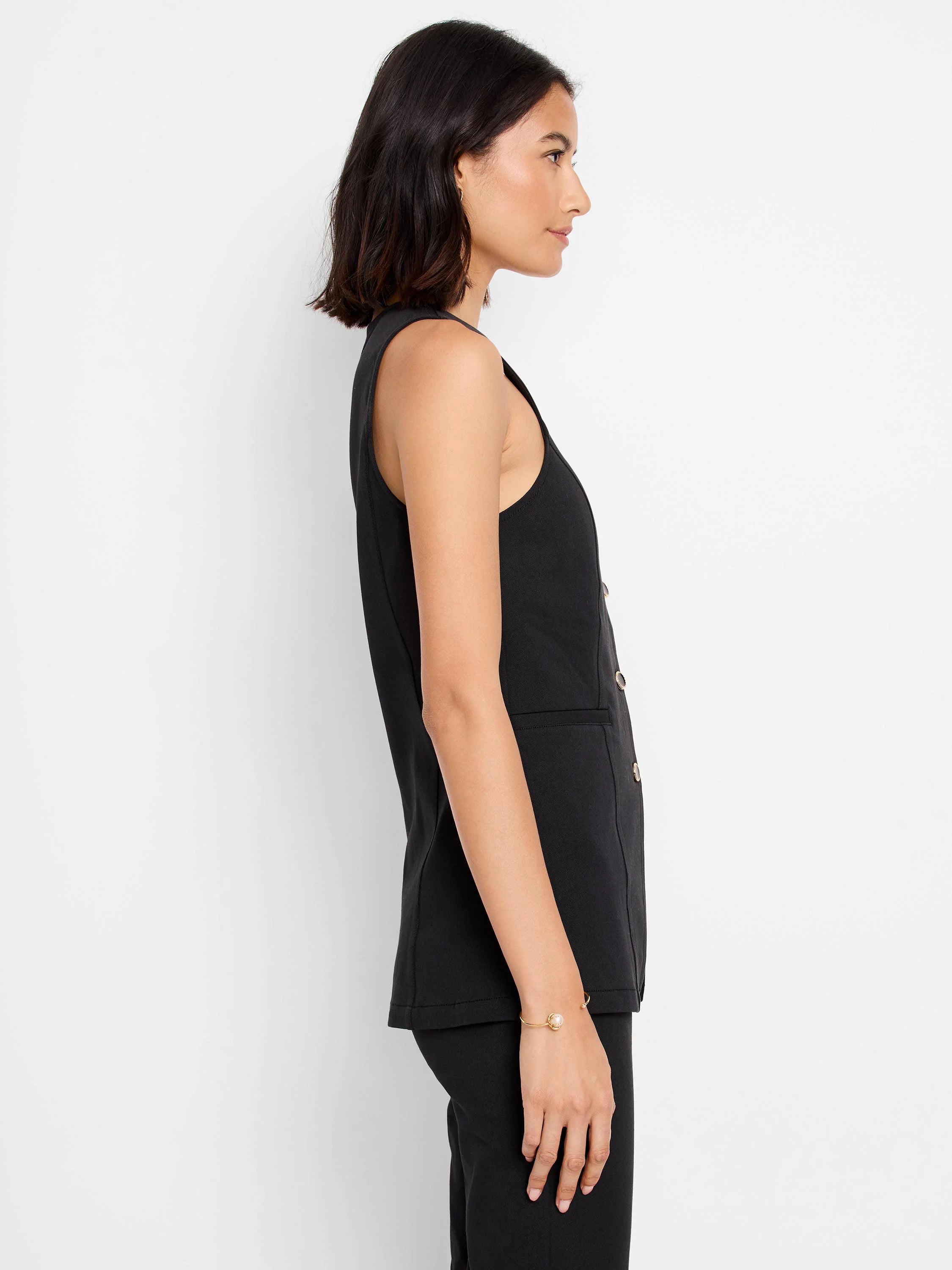Black sleeveless vest, gold buttons, split hem. Side profile view.