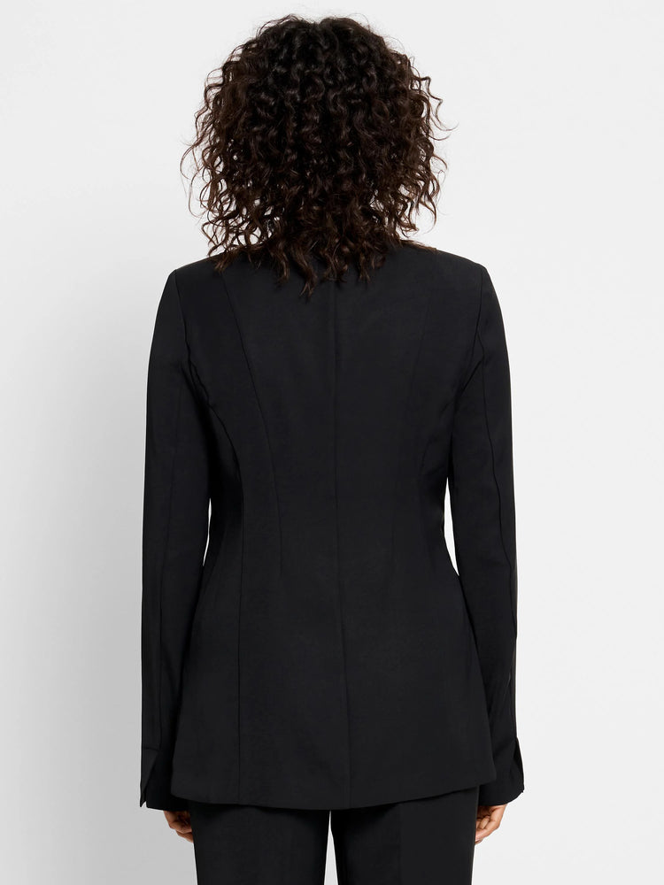 Black blazer, long sleeves, back view. Seams visible at the back.