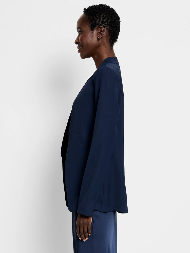 Navy blue blazer, open front, long sleeves. Side profile view.