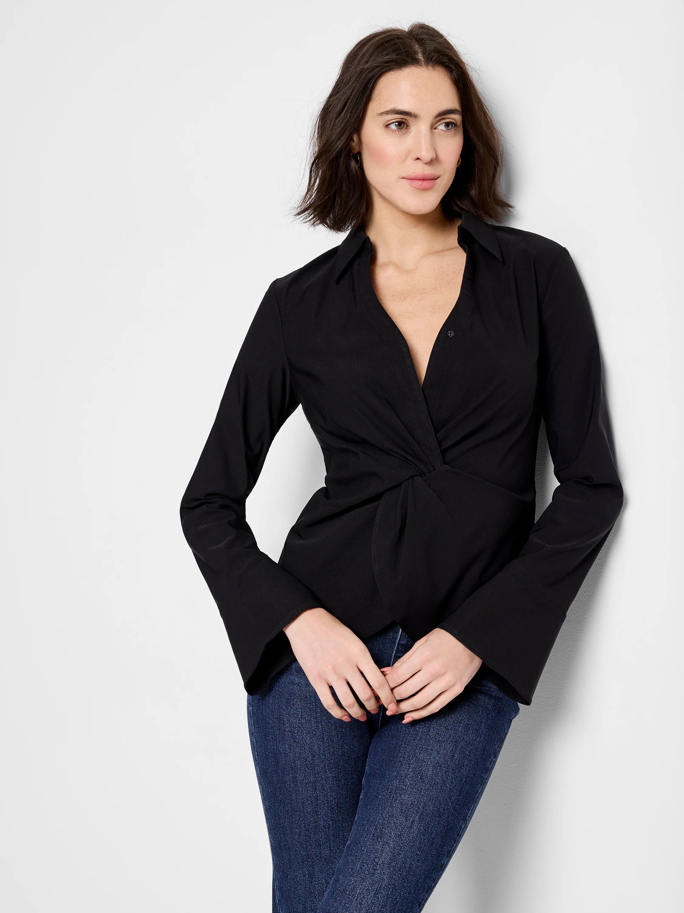 Black, long-sleeve shirt; twist front detail; collared neckline; slightly flared cuffs.