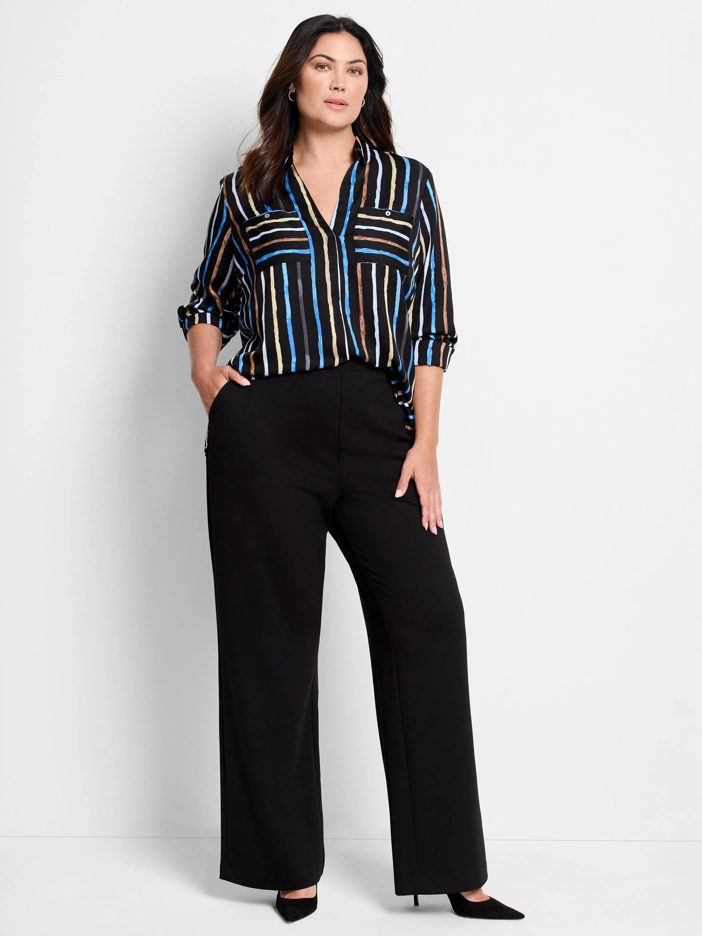 Black wide-leg pants; striped shirt with blue, brown, beige stripes on black background.