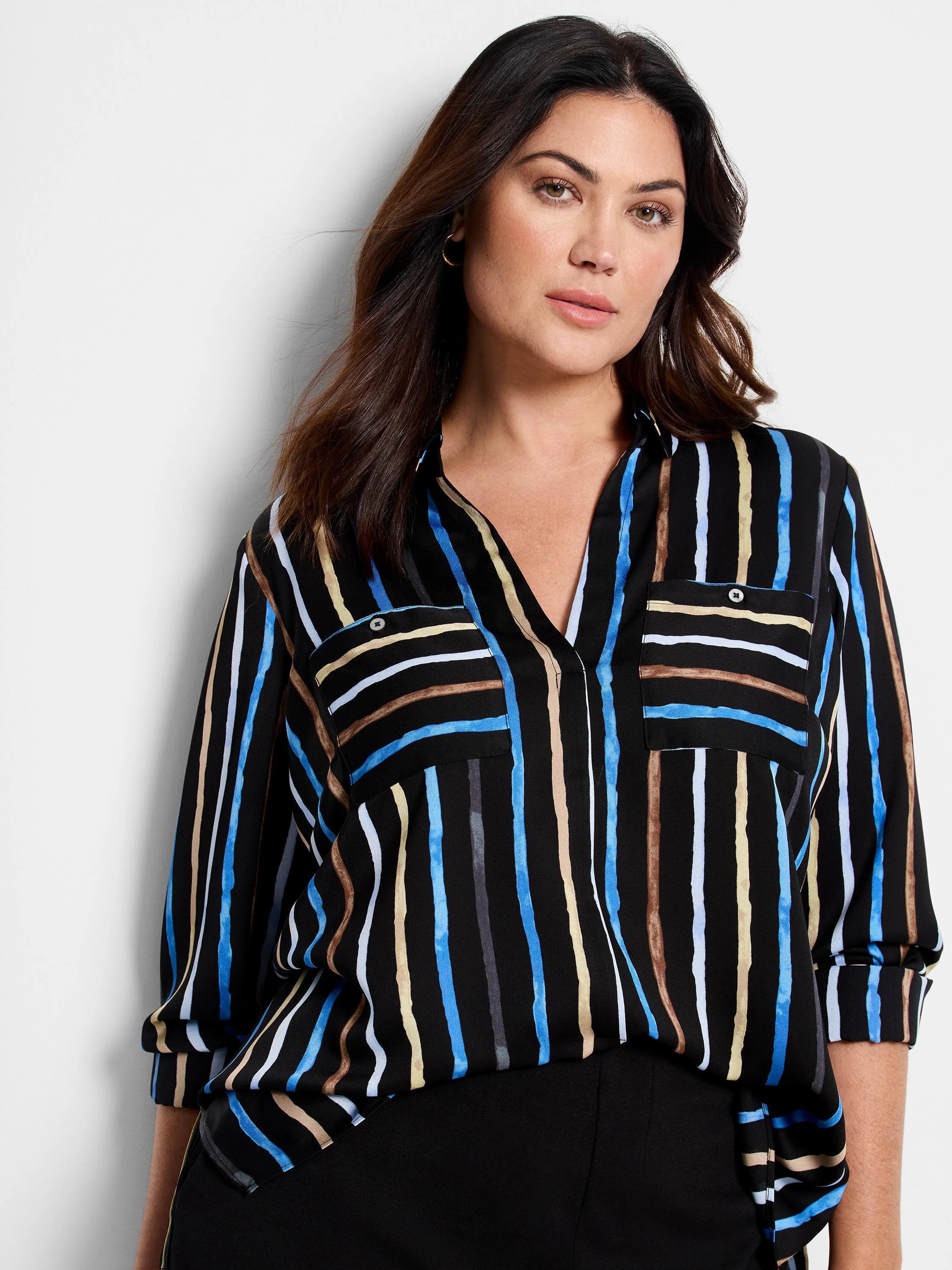 Black shirt with vertical stripes in blue, tan, and gray. Features long sleeves and chest pockets.
