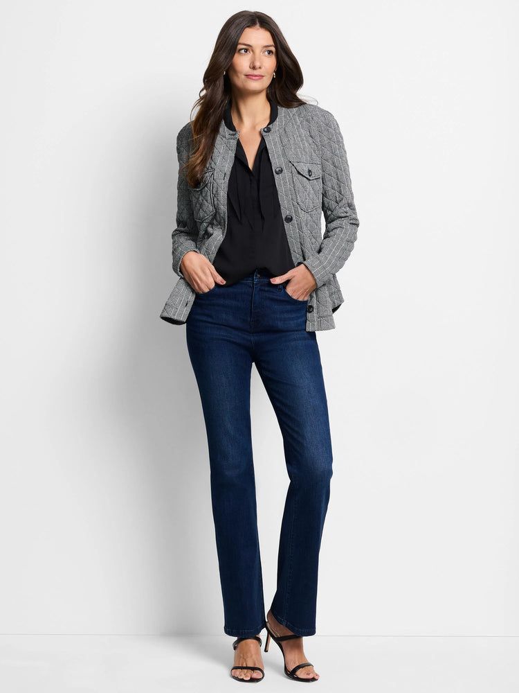 Gray and white checkered quilted jacket over black top, dark wash jeans.