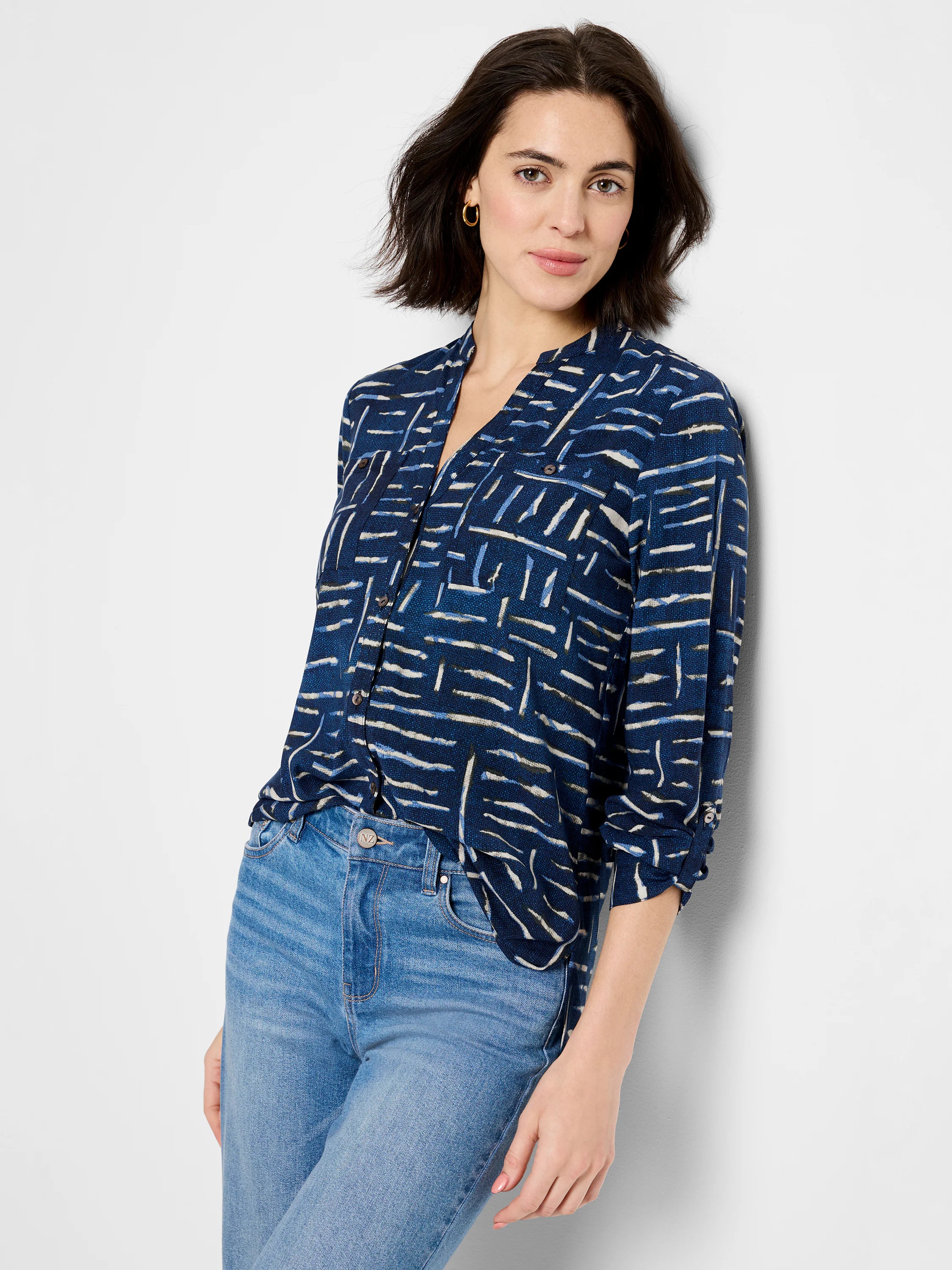 Indigo blue shirt with an abstract white and dark blue line print. Three-quarter sleeves, button front.