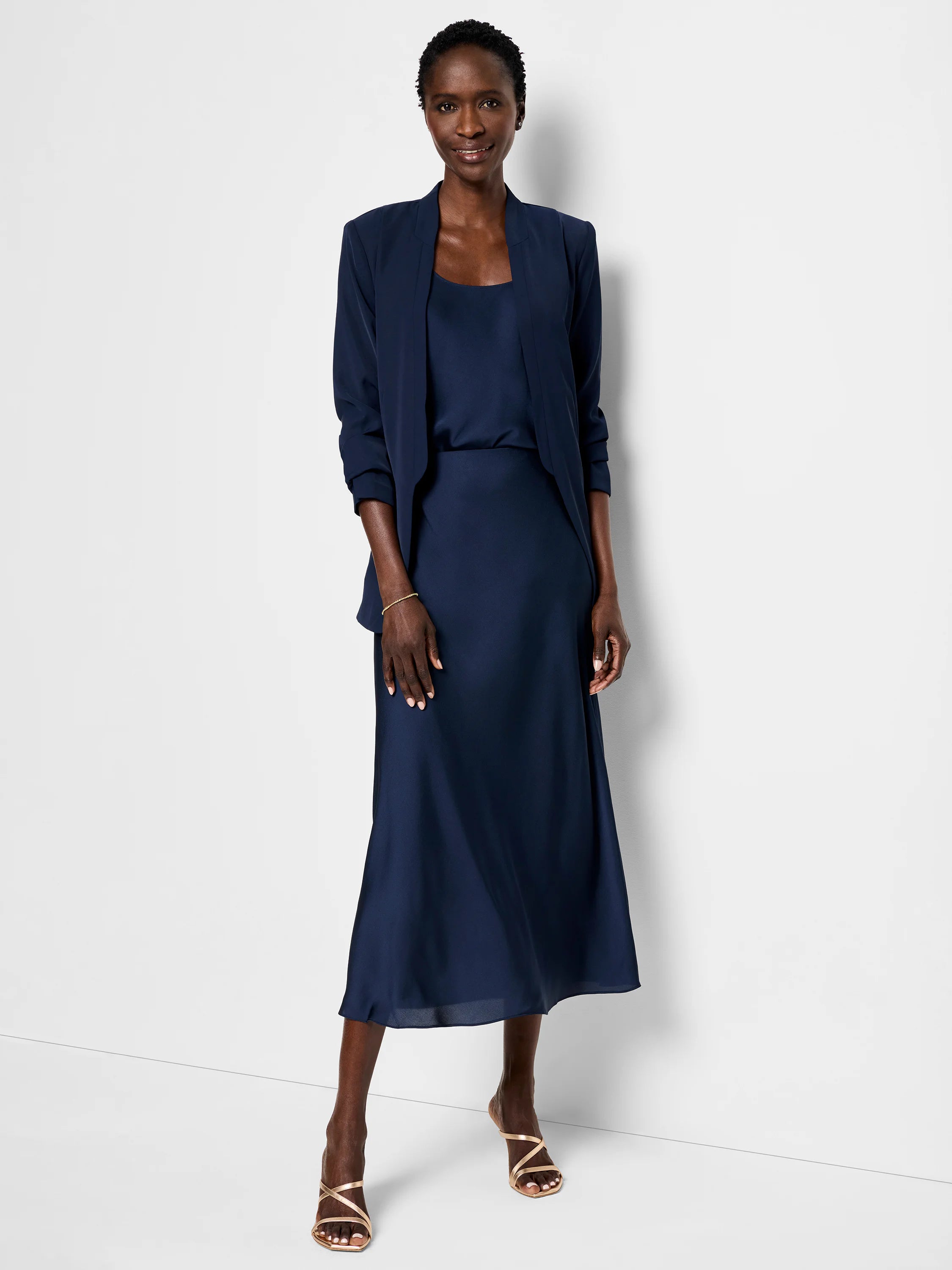 Navy blue crepe cami and midi skirt. Model wears a navy blazer.