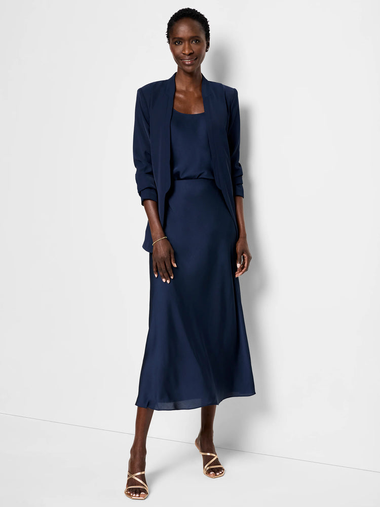 Navy blue crepe cami and midi skirt. Model wears a navy blazer.