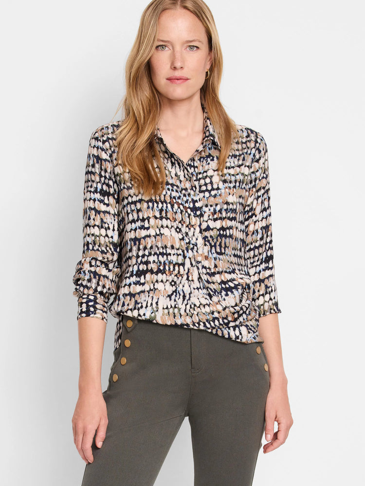 Collared button-down top features an abstract dot pattern in navy, white, tan, and light blue/green. Sleeves are rolled...