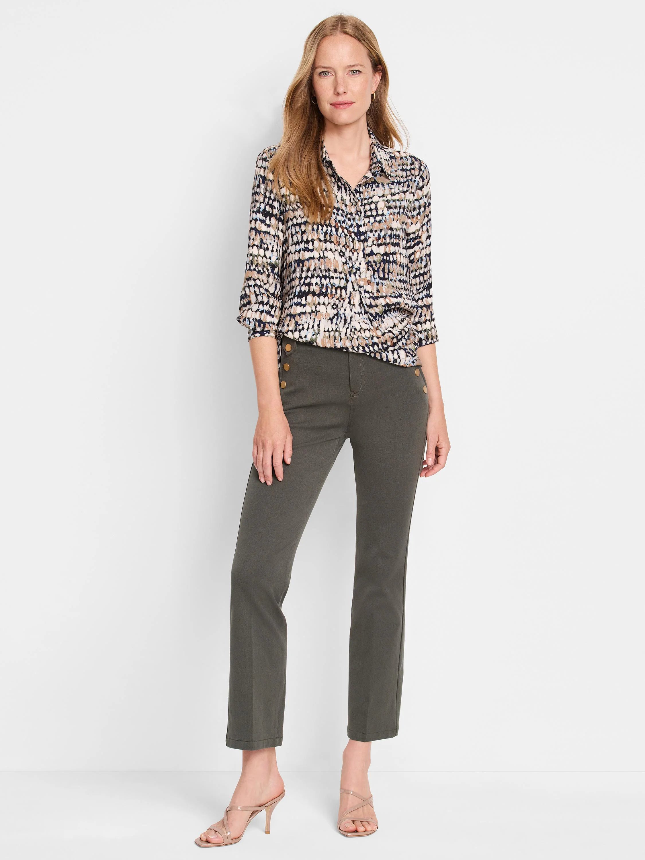 Collared button-up top with a dark base and scattered beige, olive, and light blue dots. Sleeves are worn 3/4 length.