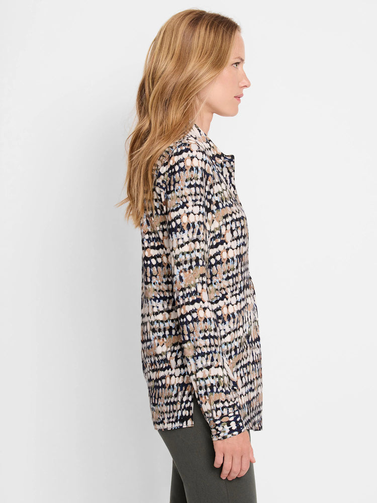Long-sleeve blouse with irregular dot pattern in cream, navy, brown, and light blue.