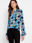 Blue, teal, beige, and black abstract print long-sleeve blouse with a V-neck and ruffled cuffs.