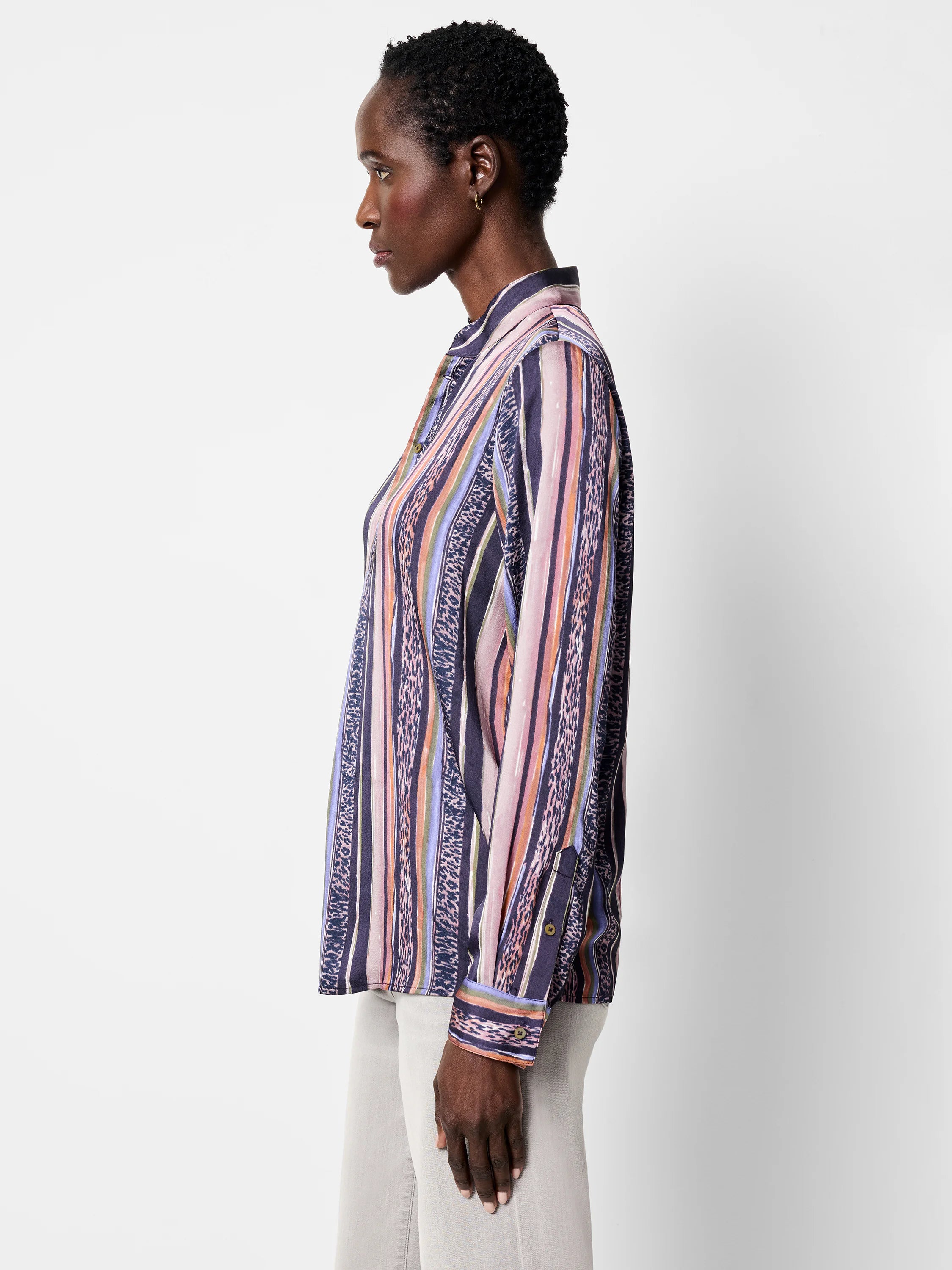 Long-sleeved button-up shirt. Vertical stripes in purple, pink, orange, and green with animal print accents.