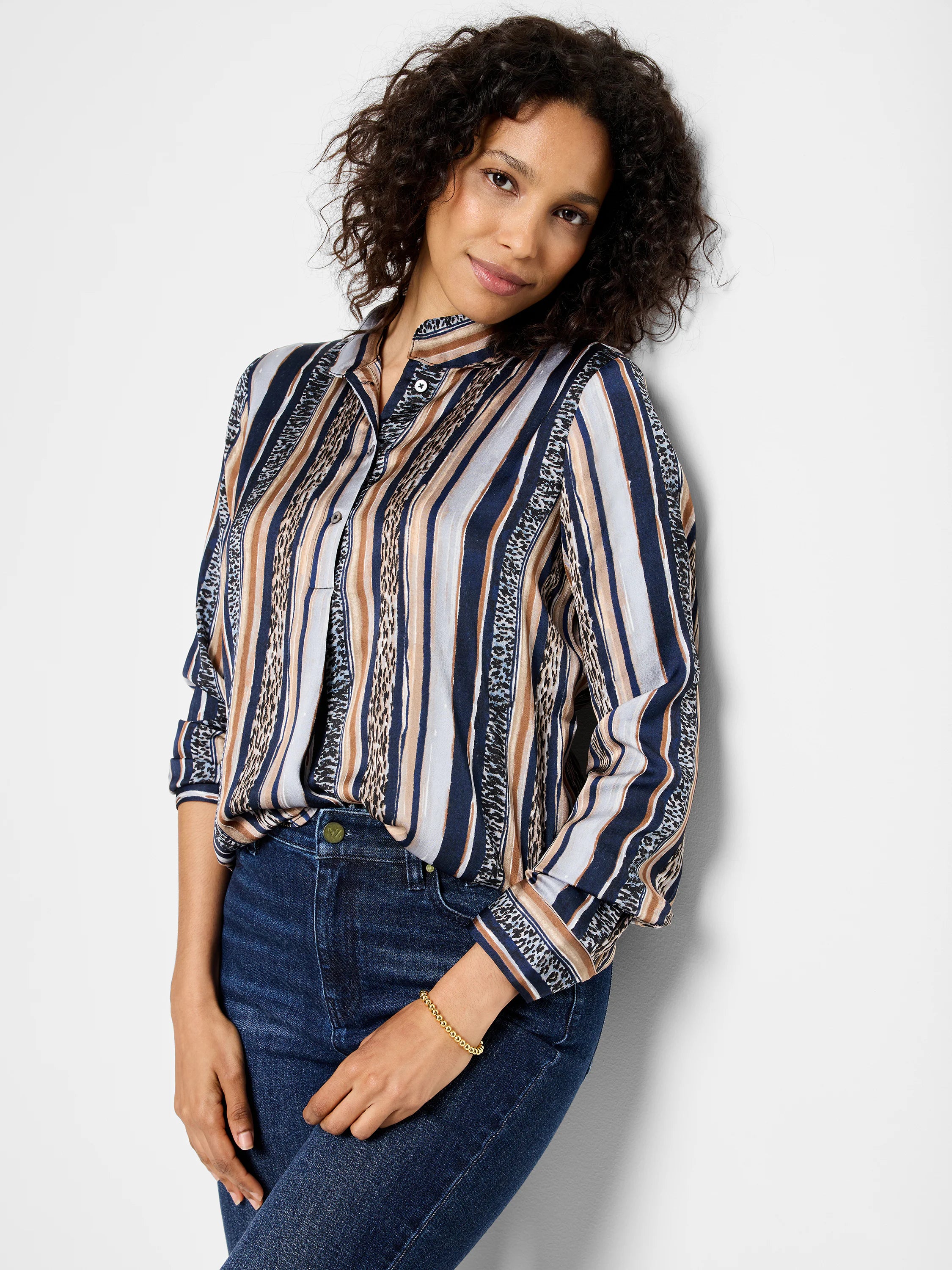 Long-sleeve button-up shirt with vertical stripes in navy, beige, and light gray. Some stripes incorporate a dark animal...