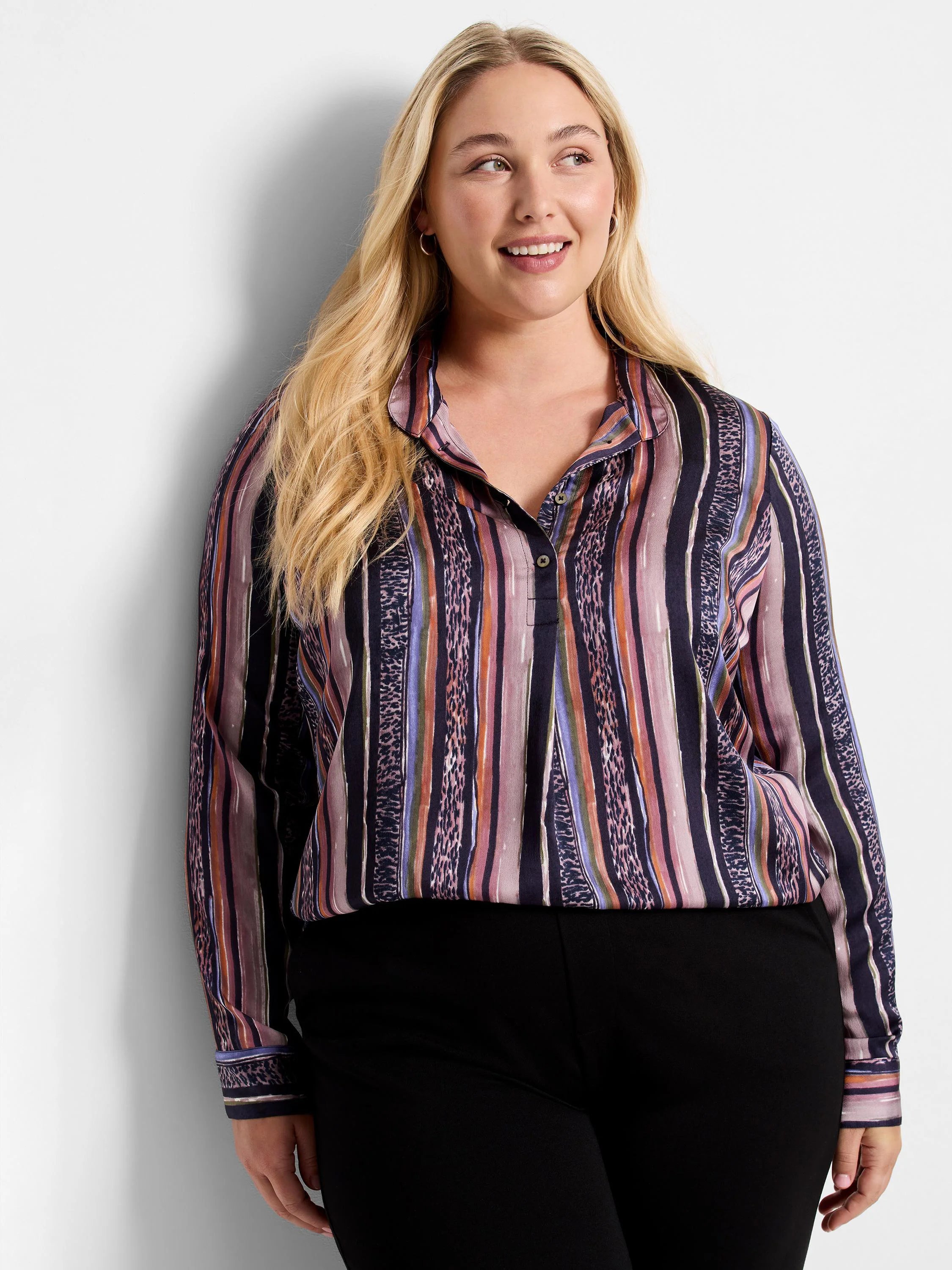 Long-sleeve button-up shirt. Vertical stripes in mauve, orange, purple, and dark teal with animal print accents on a dark...