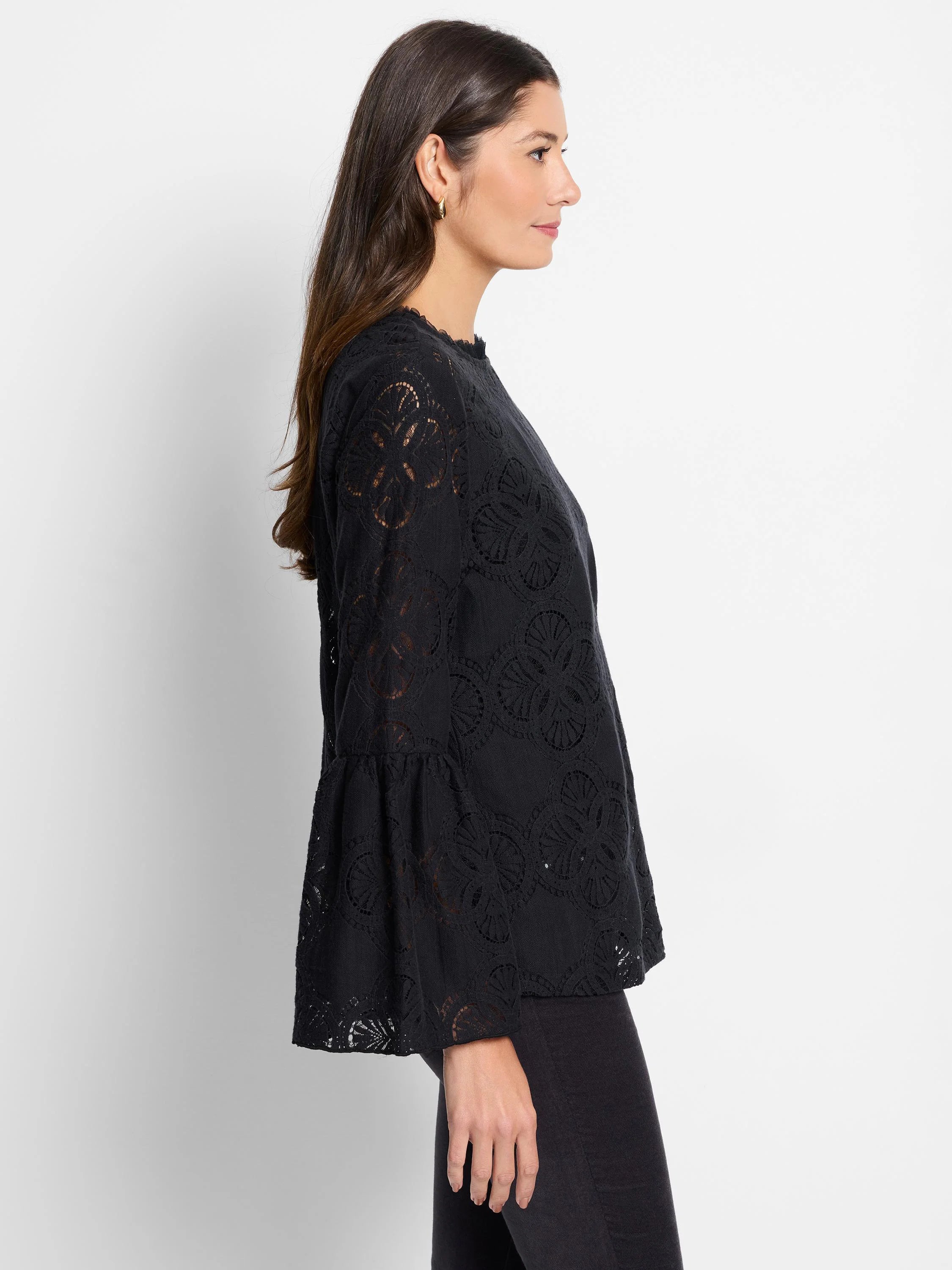 Black lace top with bell sleeves. Floral lace pattern. Round neckline.