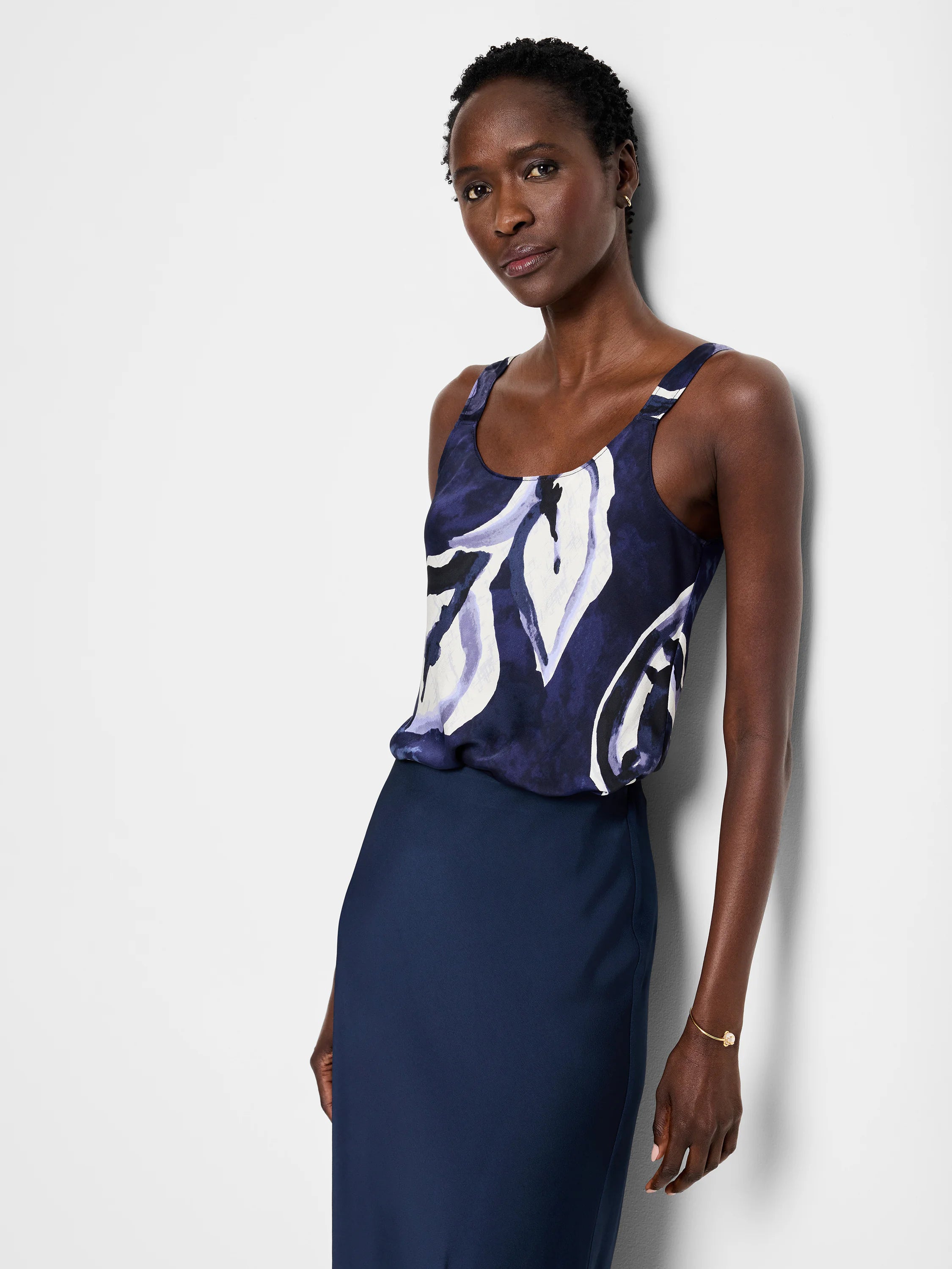 Navy cami with abstract white and purple watercolor vine print. Scoop neck, sleeveless.