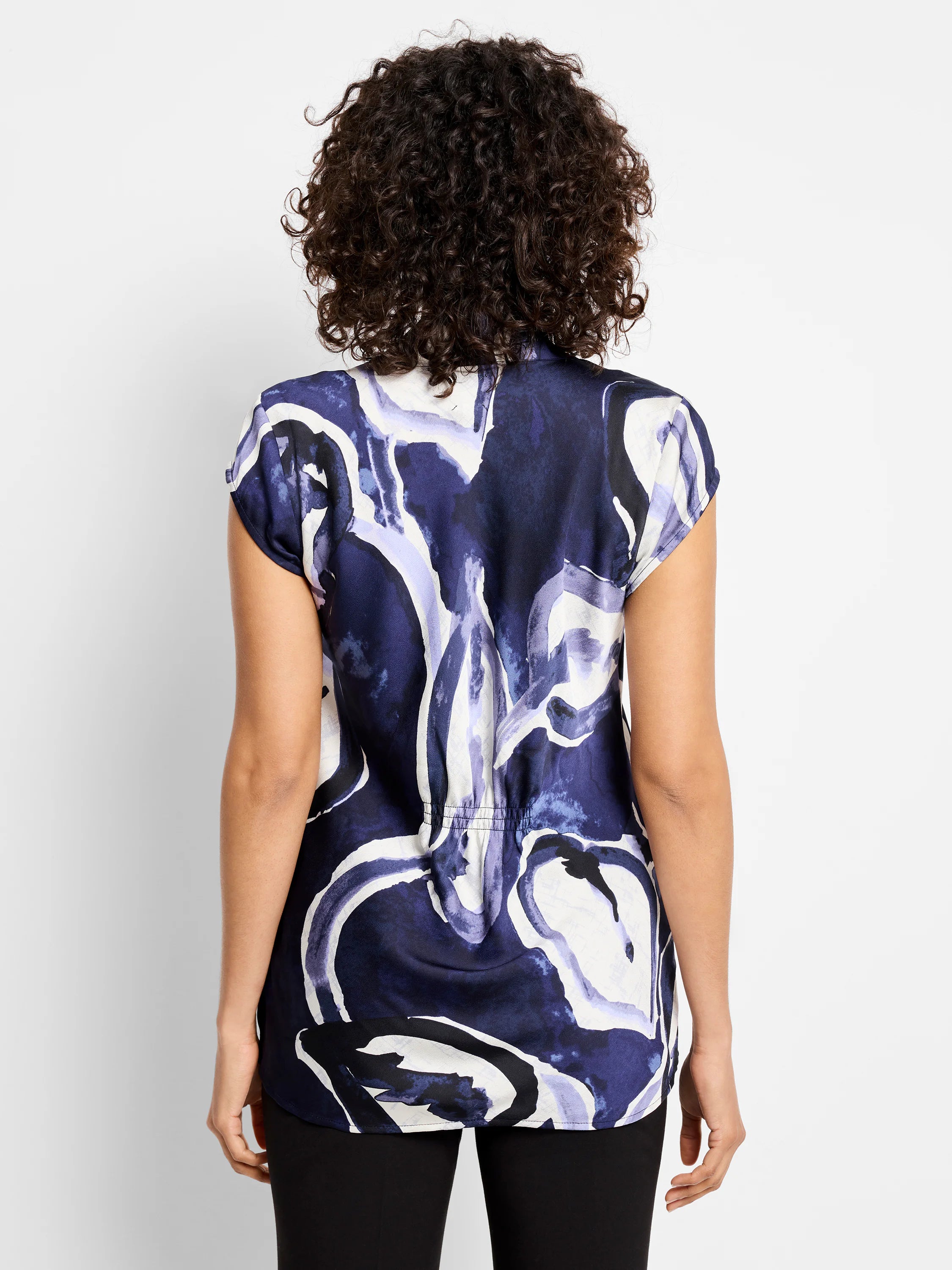 Short-sleeved top, navy blue base with abstract watercolor-style print in lighter blues and white. Back view shows a...
