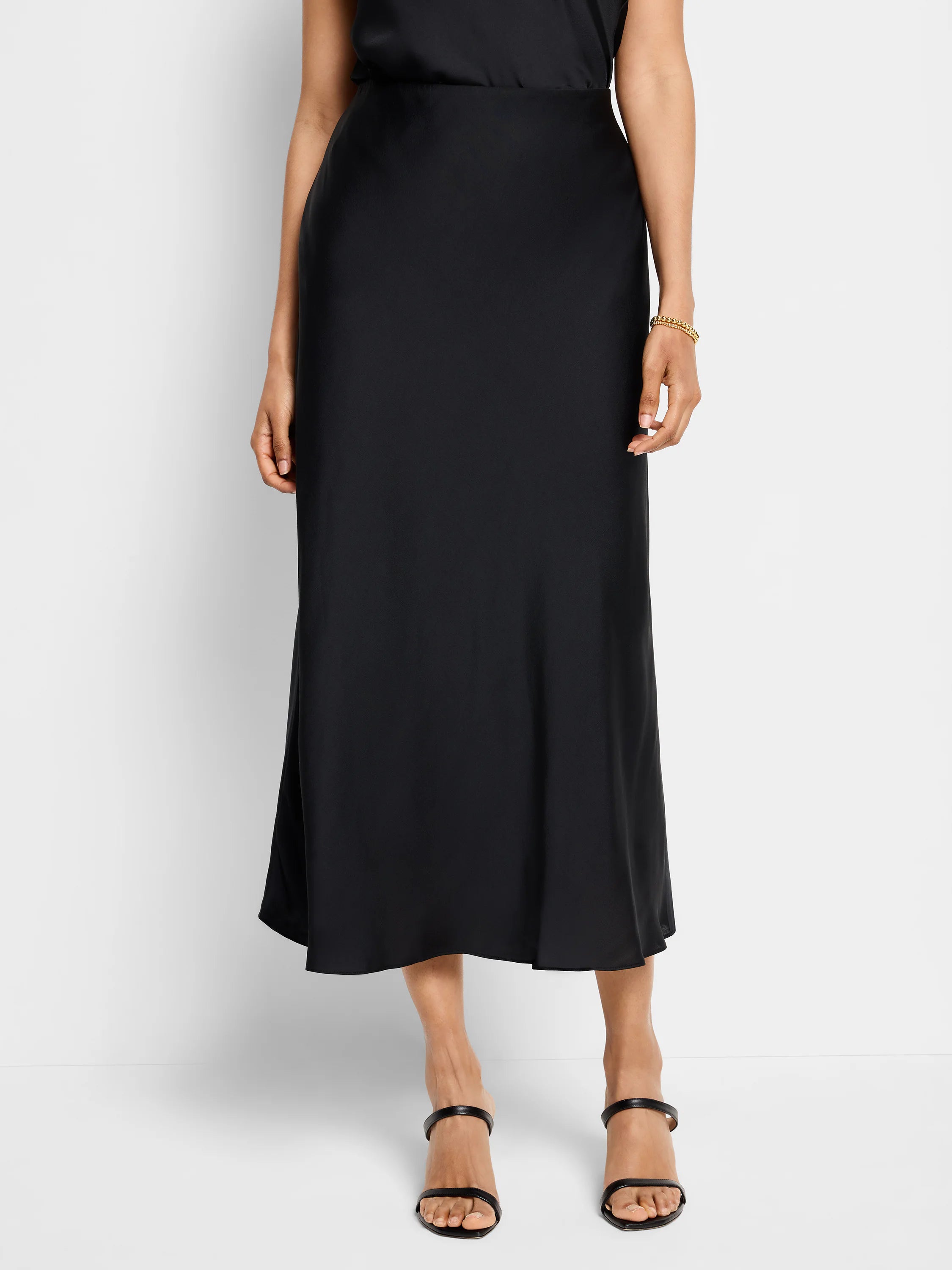 Black midi slip skirt, A-line silhouette, smooth satin-like fabric.