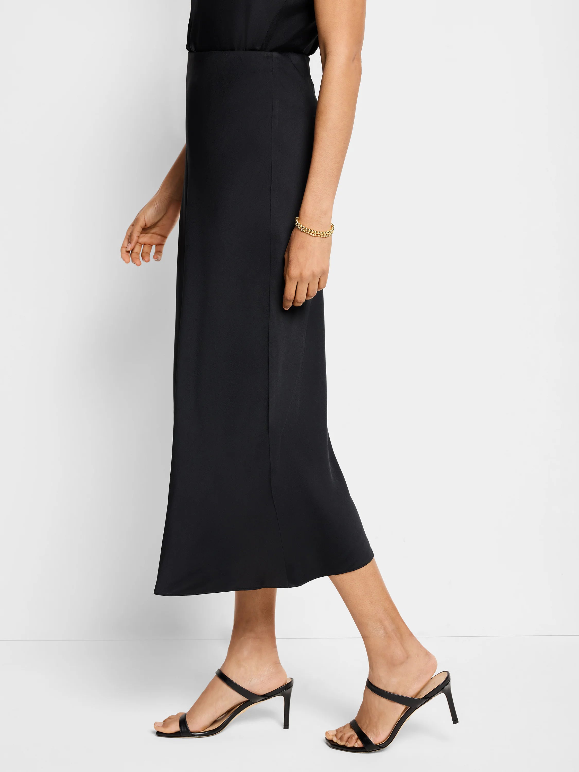 Black midi crepe slip skirt; A-line silhouette.