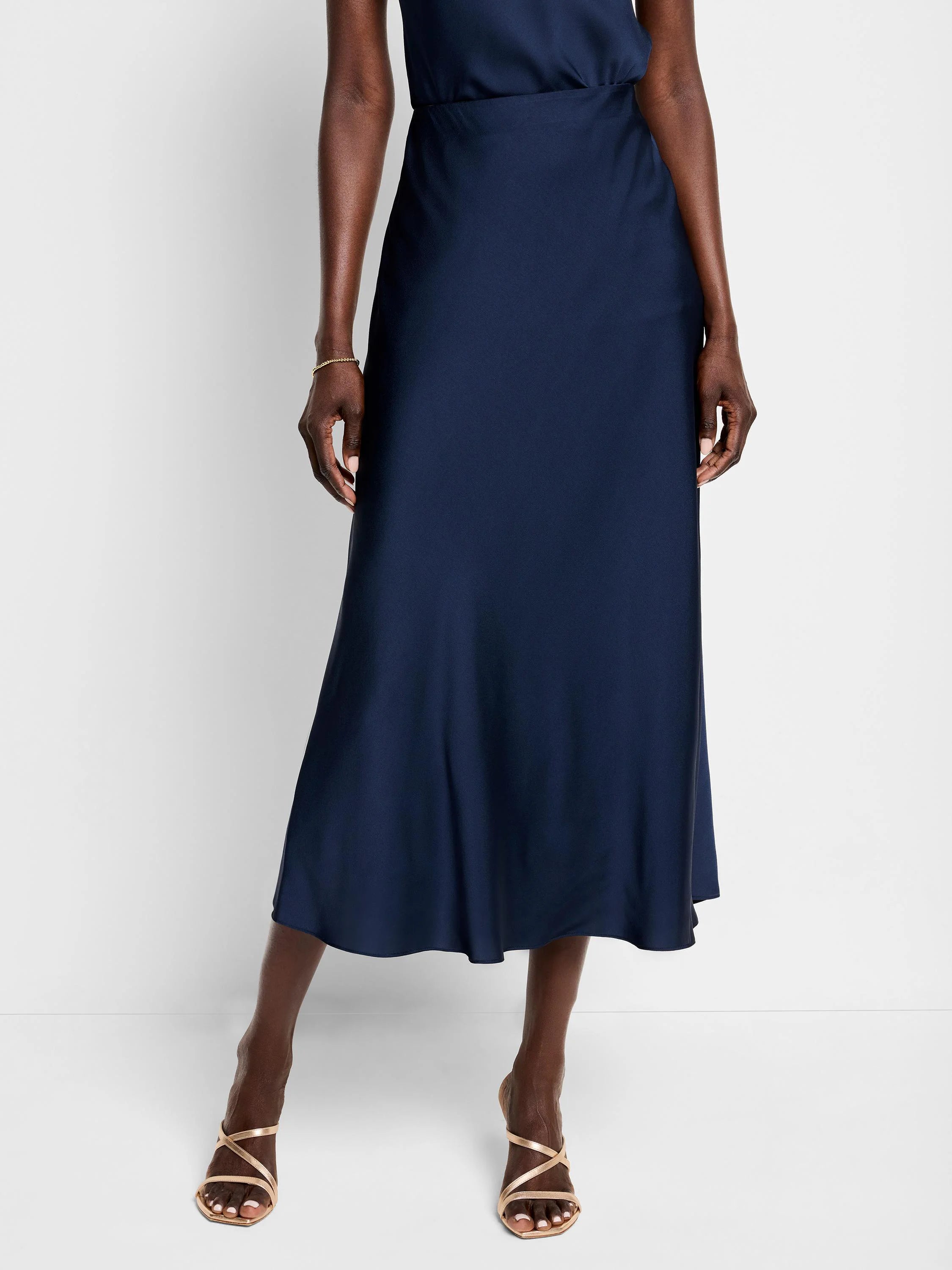 Navy blue, midi-length crepe slip skirt with a slight A-line shape.