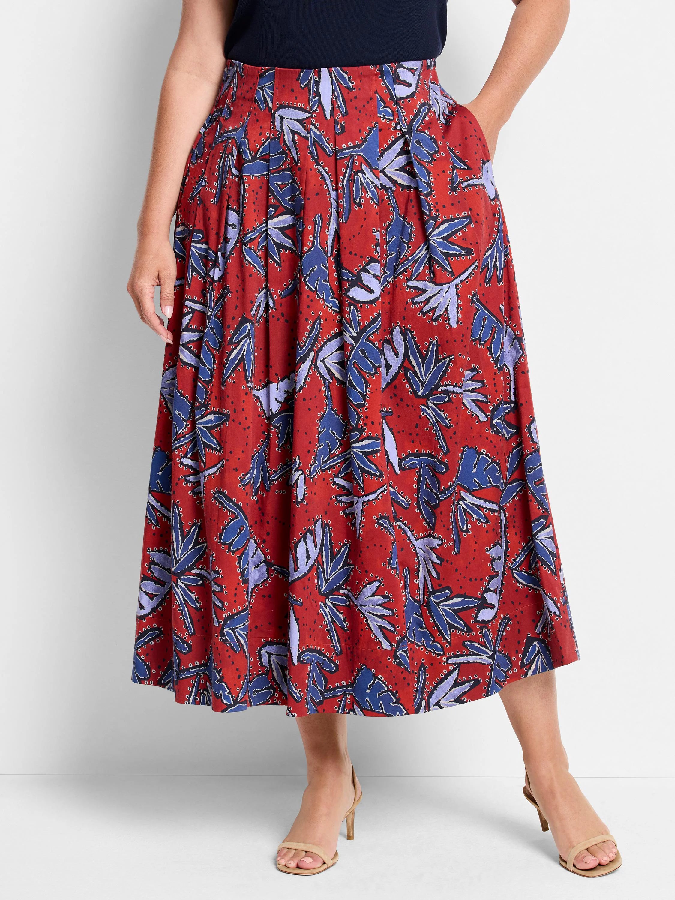 Red midi skirt with pleated front, blue and purple leaf print.