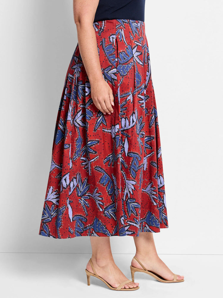 Red midi skirt with a pleated design. Features a blue and purple leaf pattern on a red background.