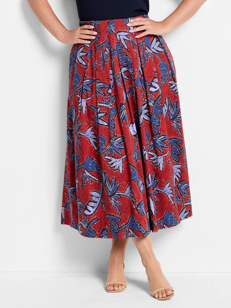 Red midi skirt with pleated blue and purple leaf print.