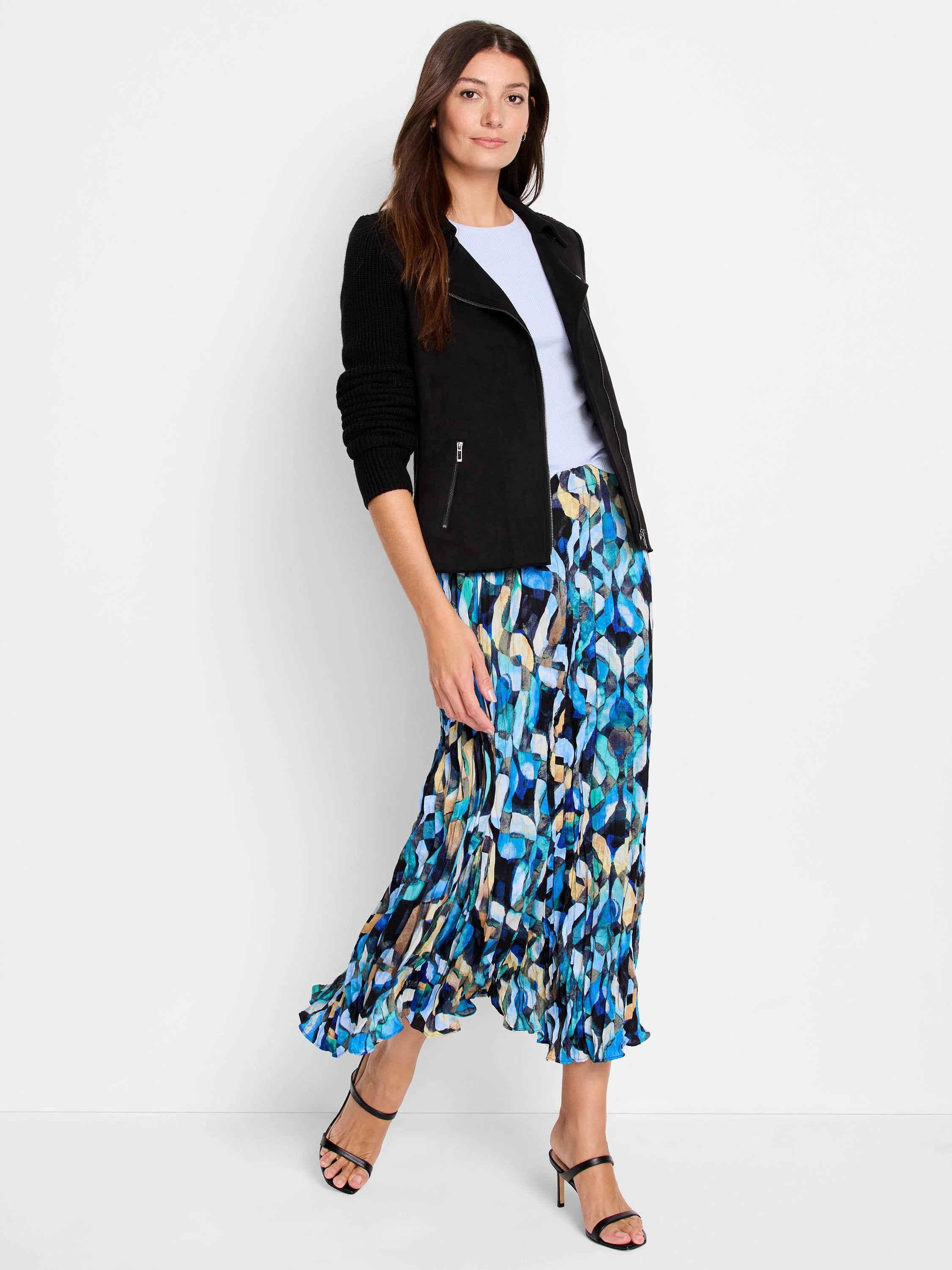 Midi pleated skirt in blue, teal, black, and beige abstract print. The pleats are visible.