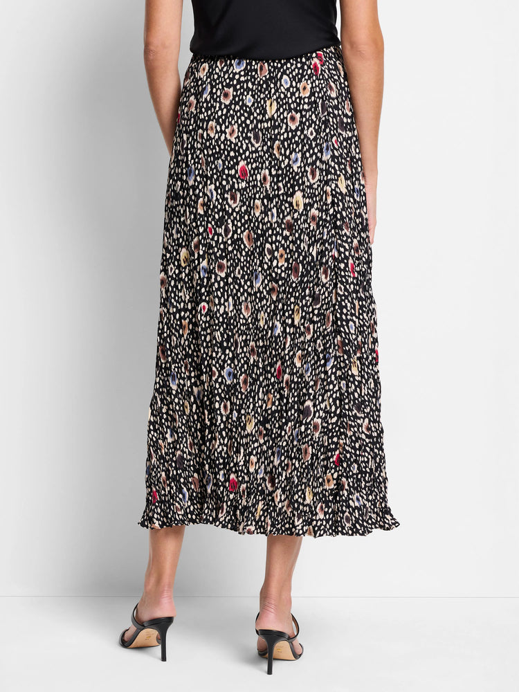 Black pleated midi skirt with multicolored spotted pattern. Beige, brown, blue, and red spots.