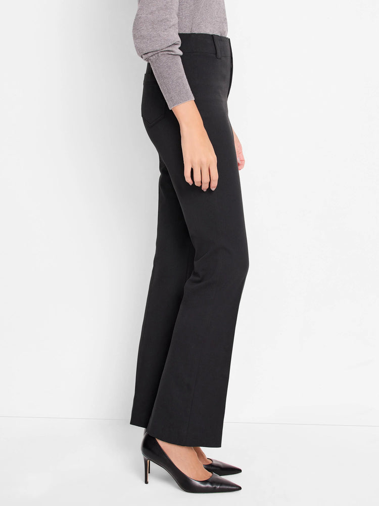 Black, bootcut pants shown on a model. The pants have a mid-rise waist.
