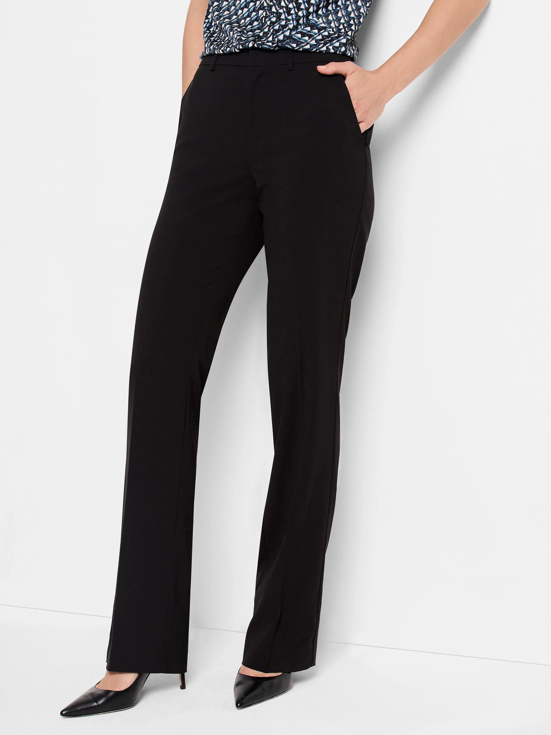 Black bootcut trousers shown on a model. The pants have pockets.