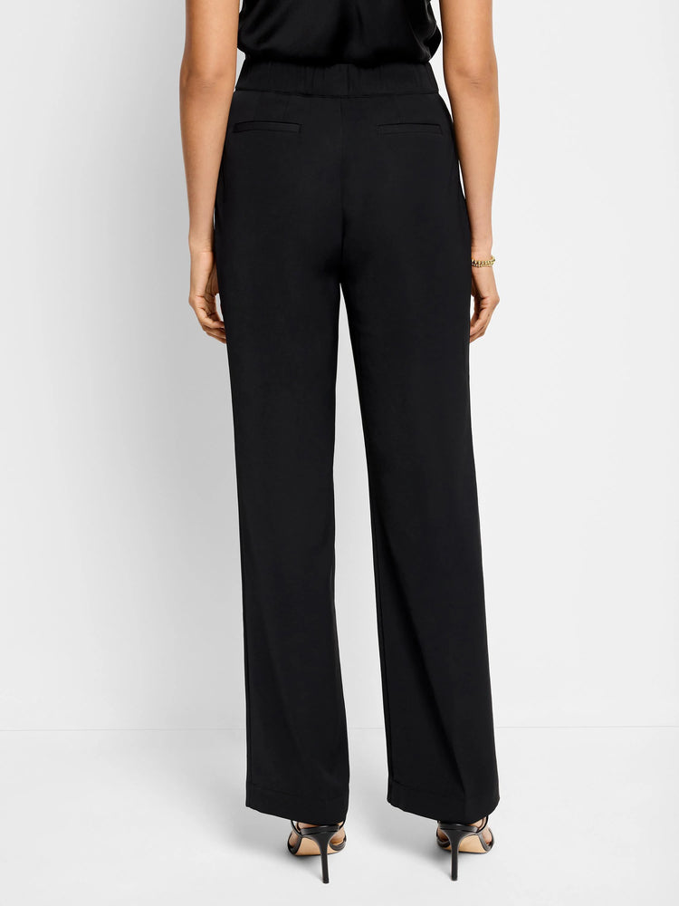 Here's alt text for the image, under 125 characters:
Black wide-leg trousers, shown from the back. Elastic waistband,...