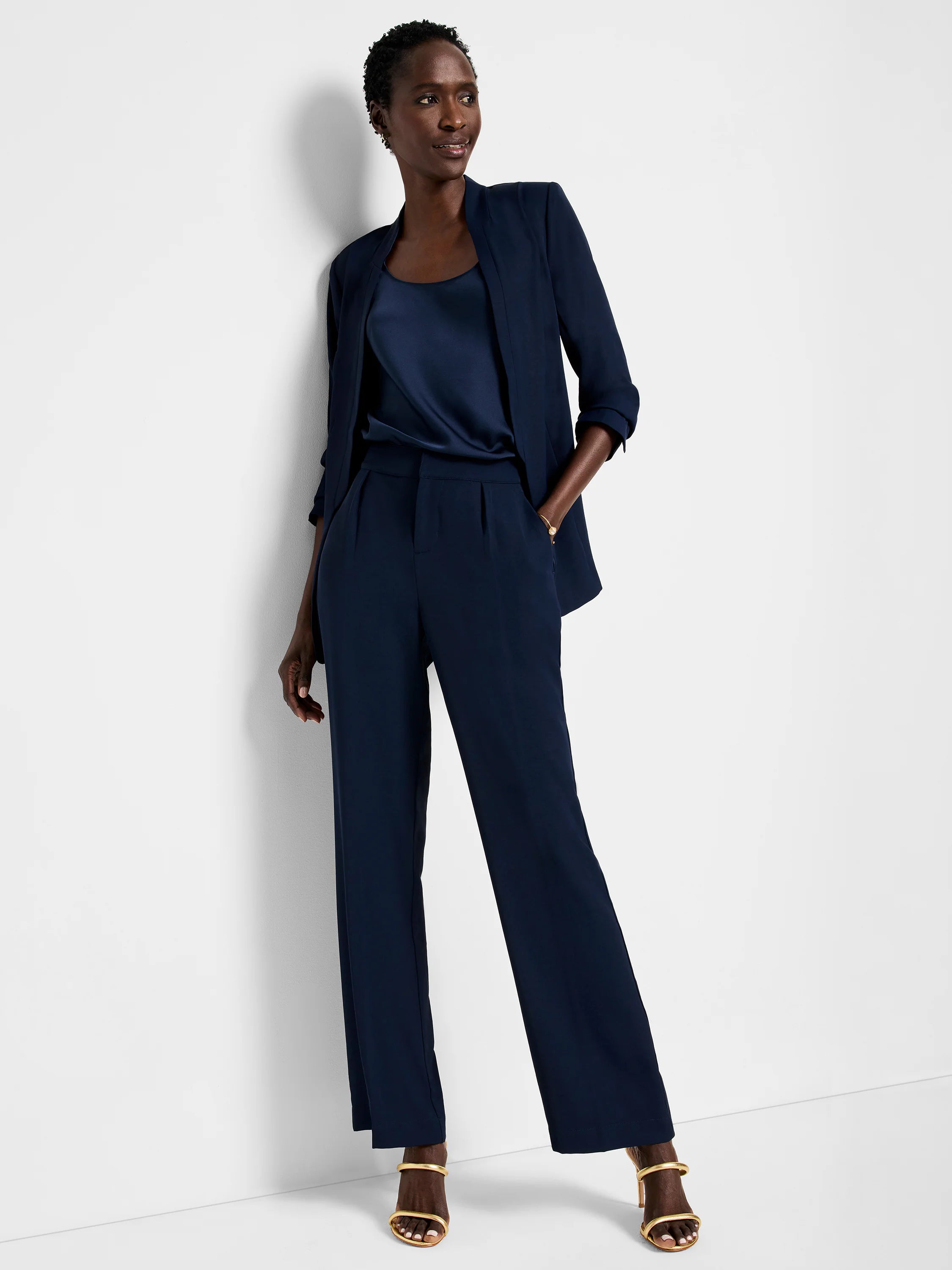 Navy blue wide-leg trousers; model shown wearing them with a navy blazer and top.