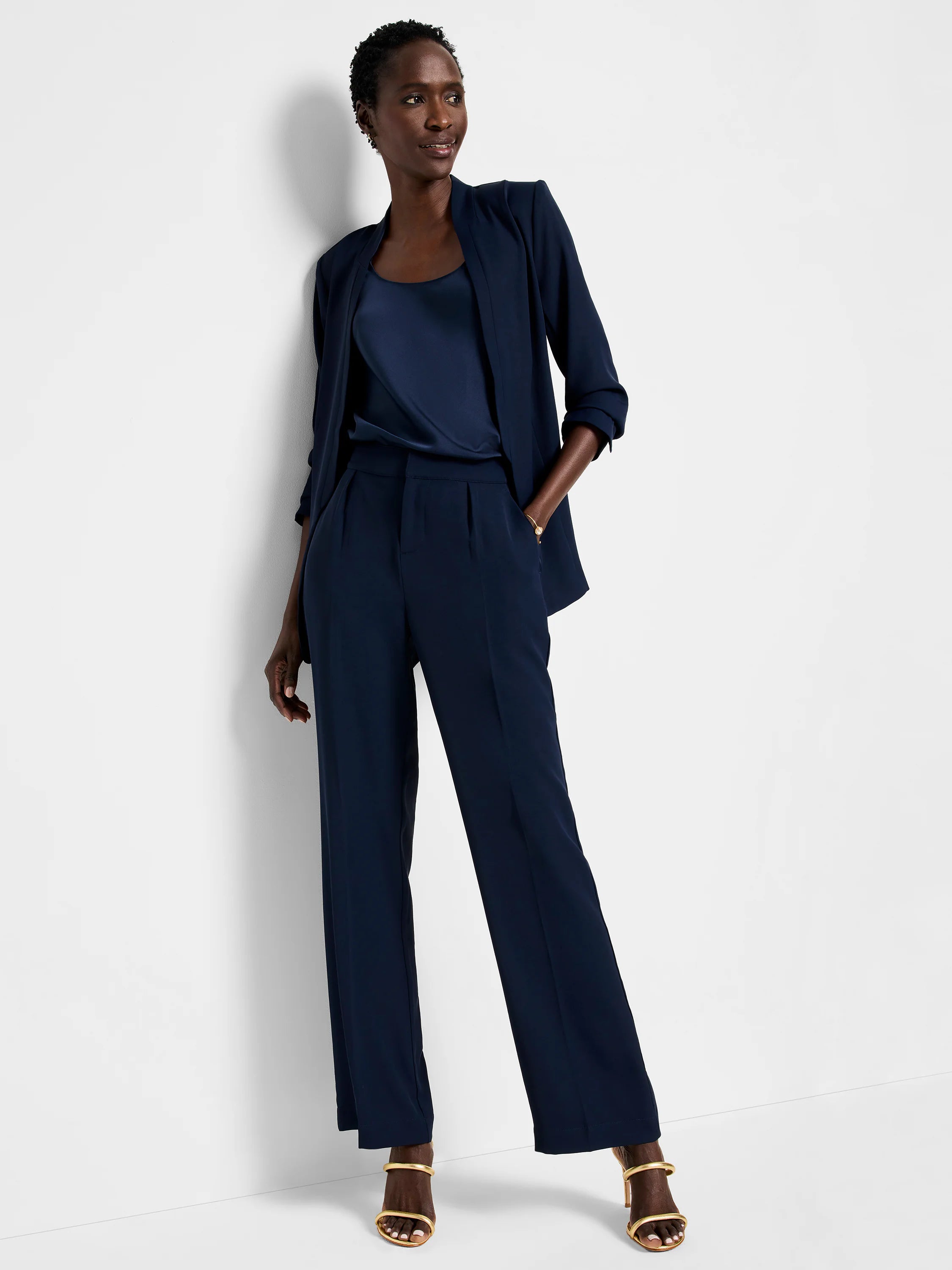 Navy blue wide-leg trousers; model shown wearing them with a navy top and jacket.