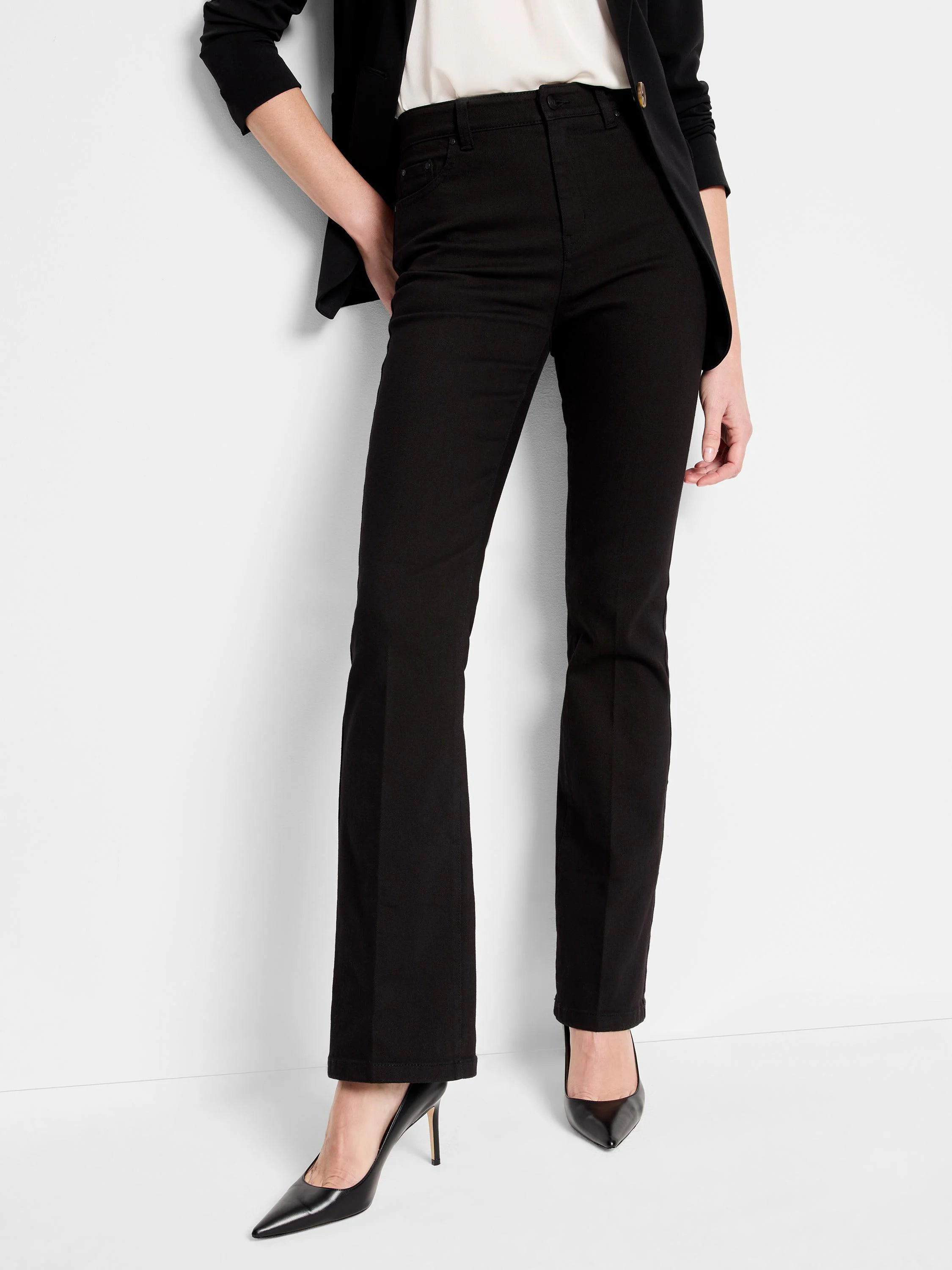 Black bootcut jeans; high-rise waist; model wearing black shoes.