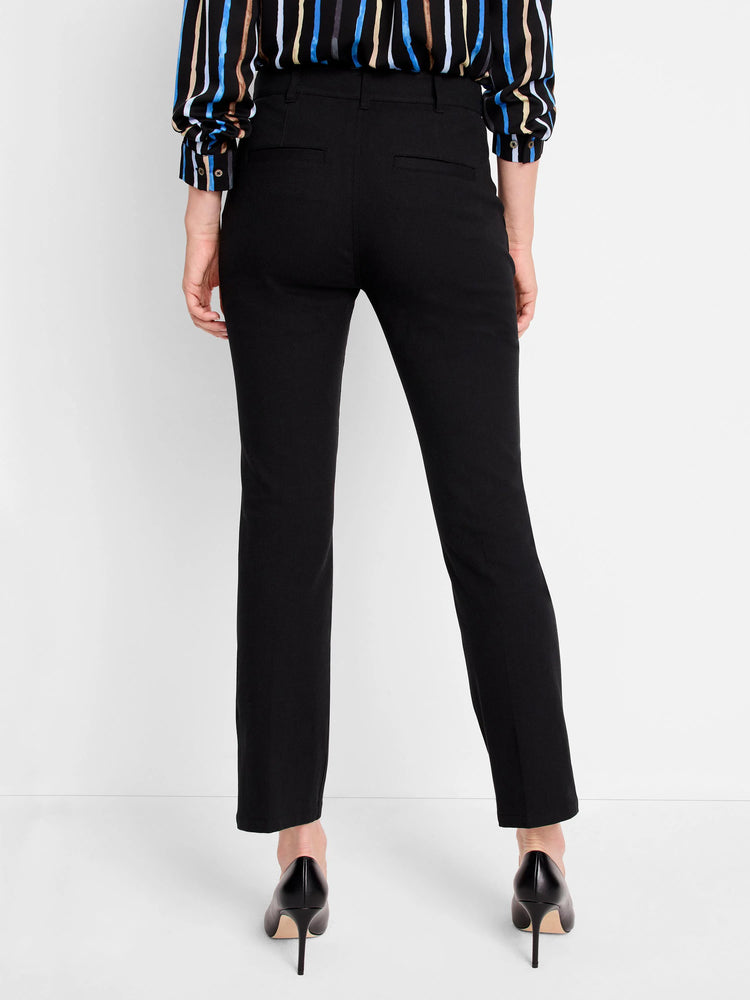 Black ankle-length pants; rear view. Model wears black heels.