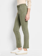 Faded olive green straight carpenter jeans, visible utility pockets and accent stitching.