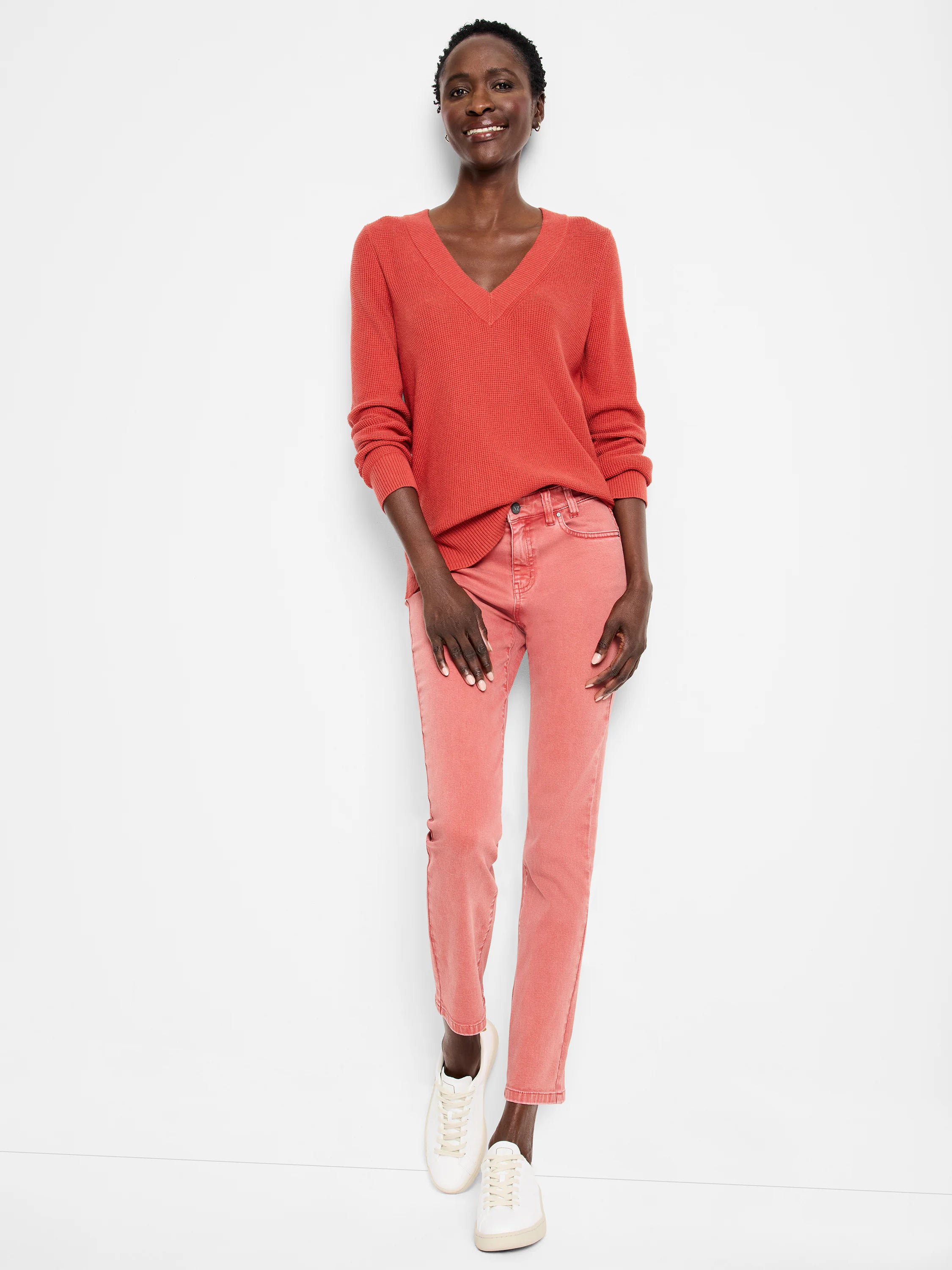 Faded coral pink straight ankle jeans.