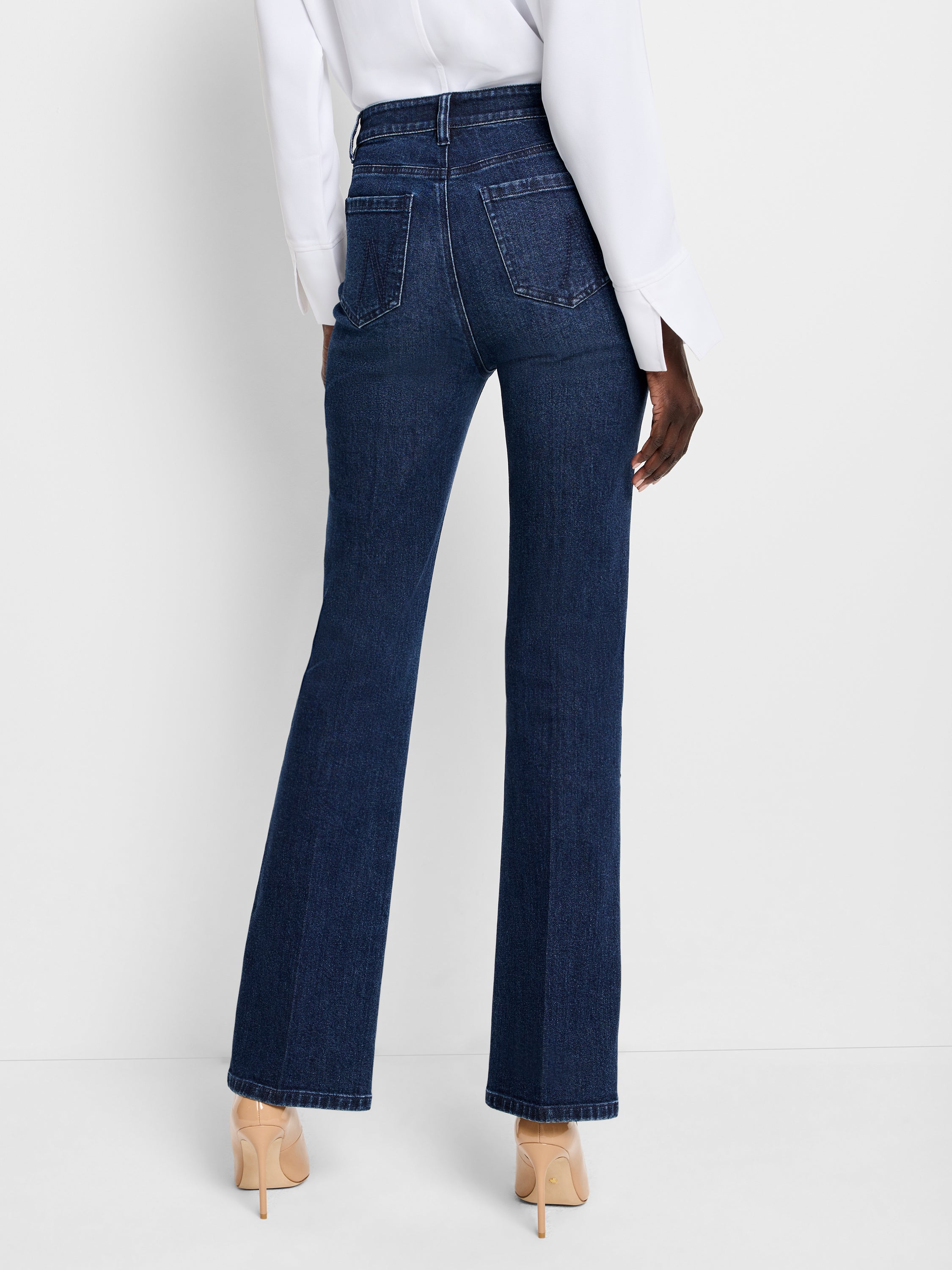 Dark wash high-waisted denim jeans feature a slim fit through the thigh with a subtle flare leg opening.