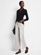 Faded light gray wide leg jeans with a cropped, frayed hem.