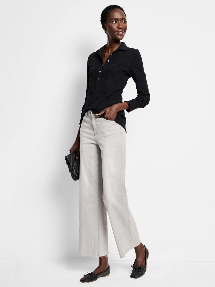 Faded light gray wide leg jeans with a cropped, frayed hem.