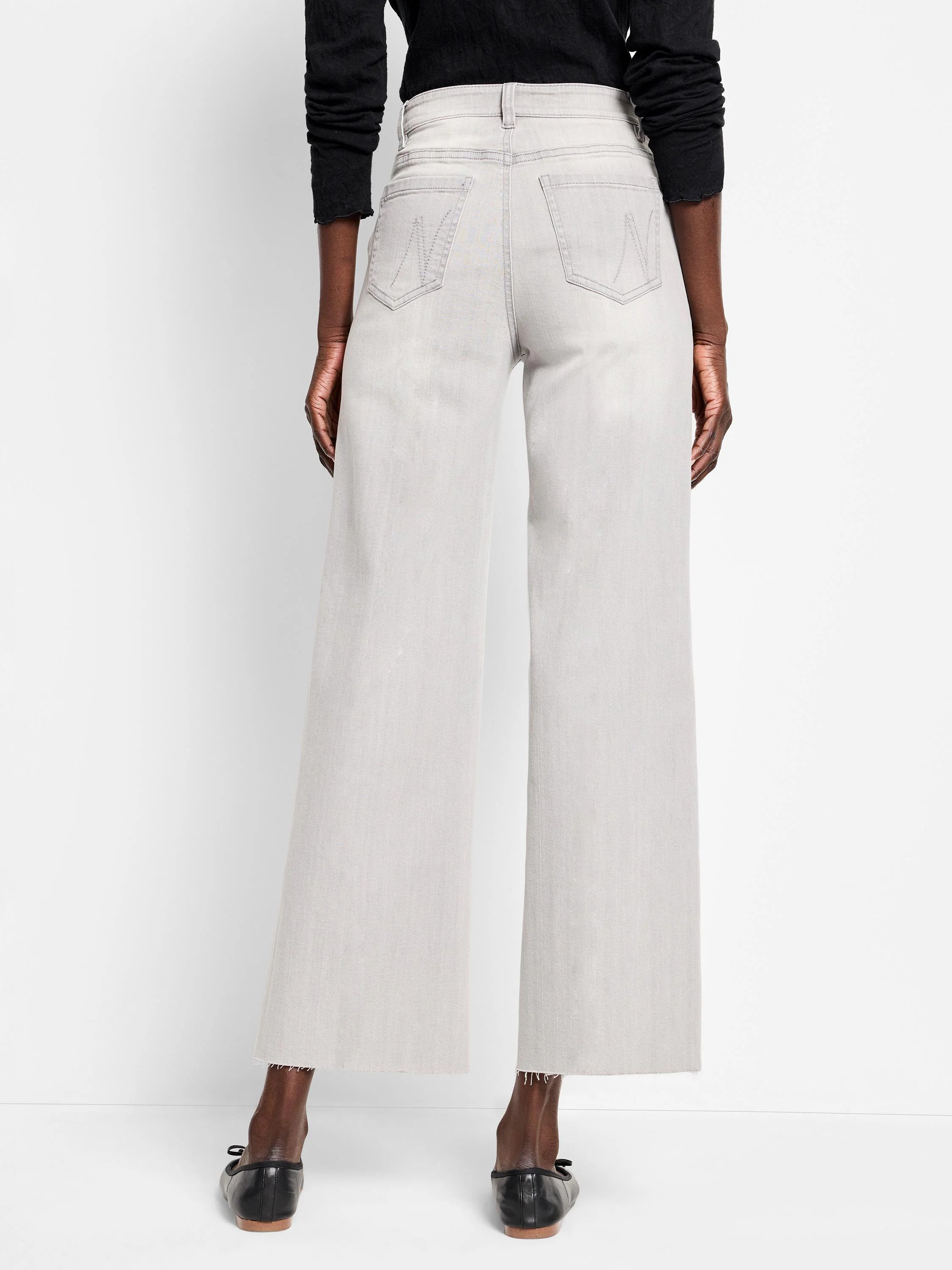 Pale grey wide leg jeans, back view, with stitched back pockets and frayed hems.