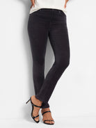 Dark gray velvet straight-leg ankle pants.  Model is wearing them with black heels.