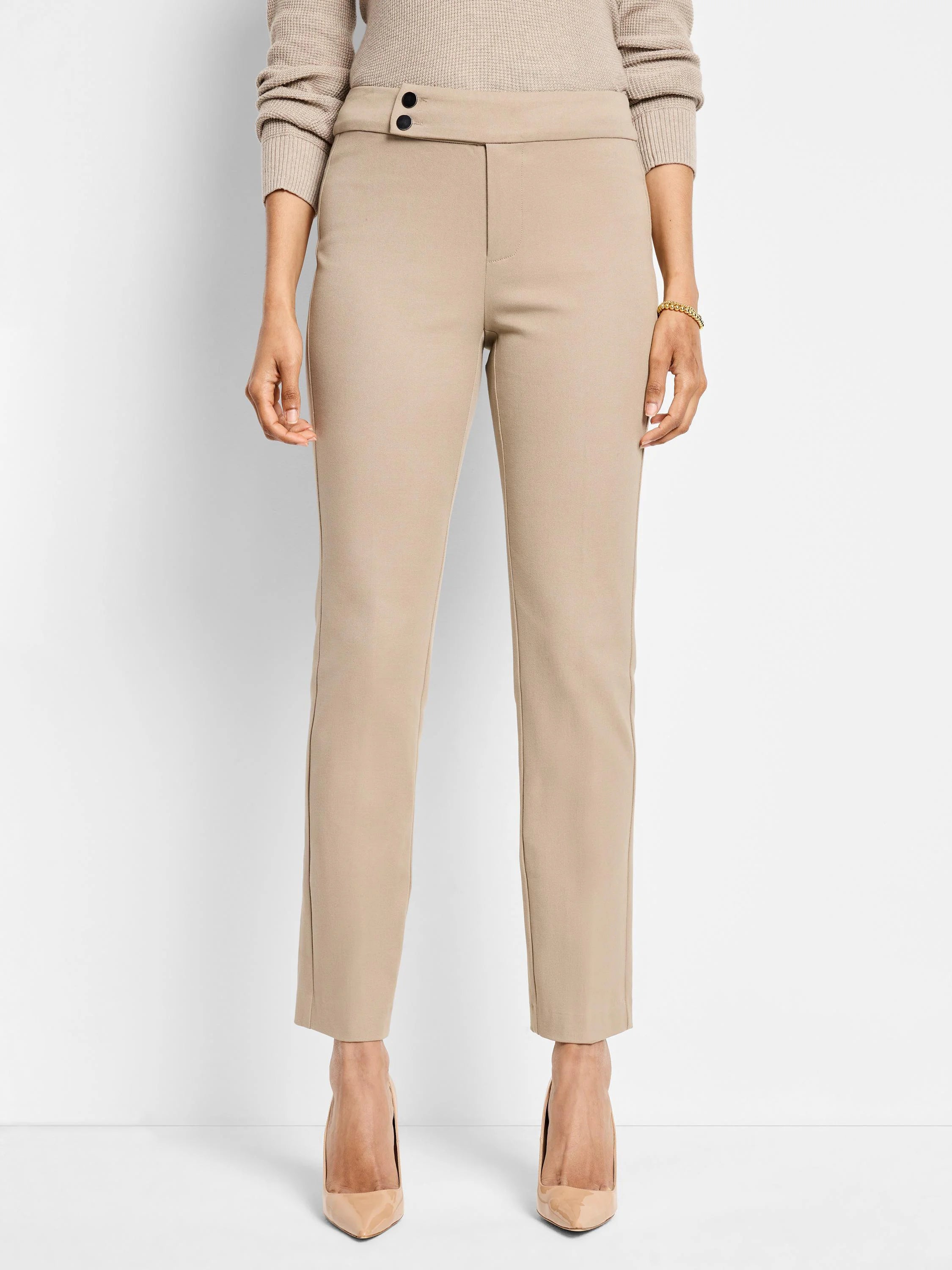 Beige straight-leg pants with a hidden button closure.  The pants are shown on a model.