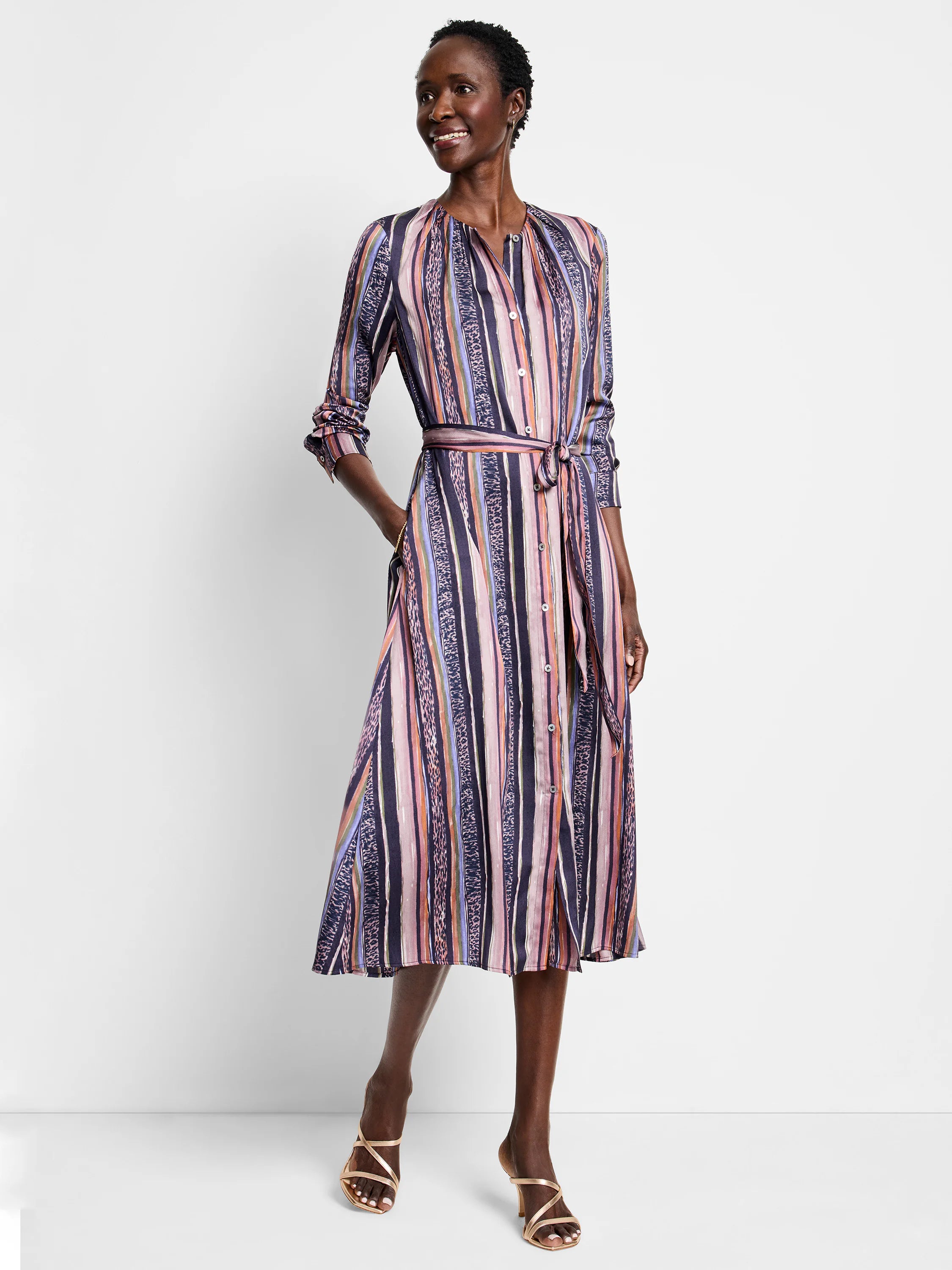 Midi shirt dress with vertical stripes in purple, pink, orange, and brown. Features a self-tie belt and pockets.