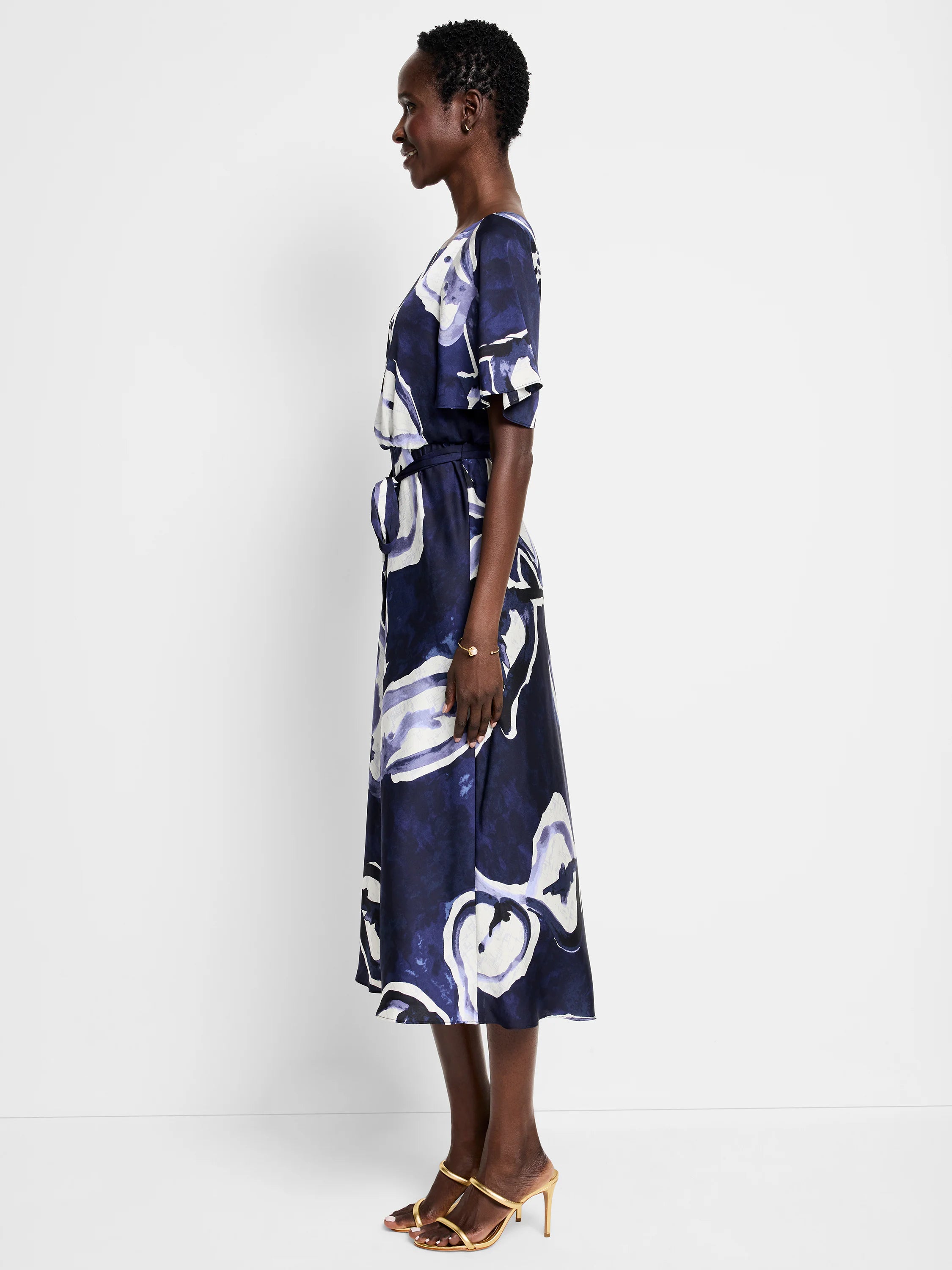 Mid-length belted dress, navy blue background with off-white and purple watercolor vine print. Short sleeves.