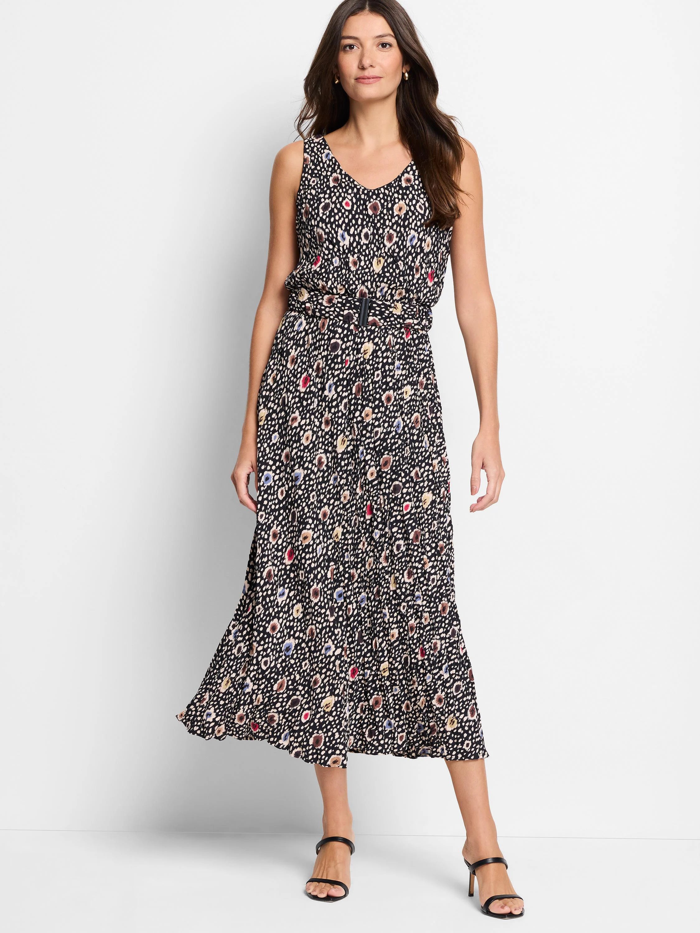 Black midi dress with multicolored spotted pattern, belted waist, and sleeveless bodice.