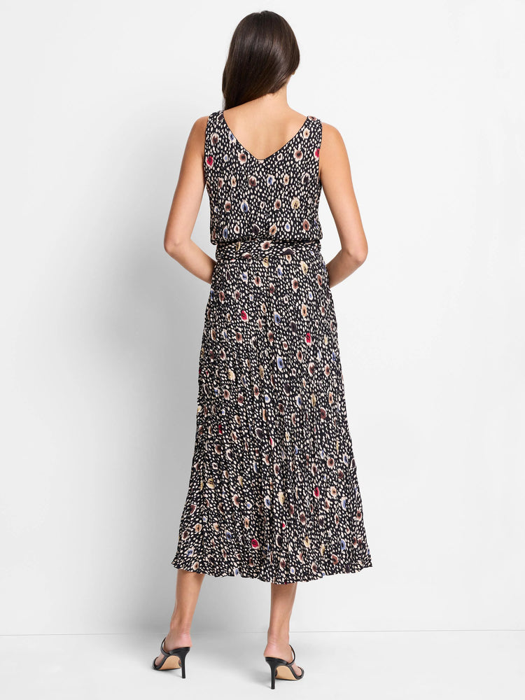 Black midi dress with multicolored spotted pattern, pleated skirt, and V-neck sleeveless bodice. Belted waist.