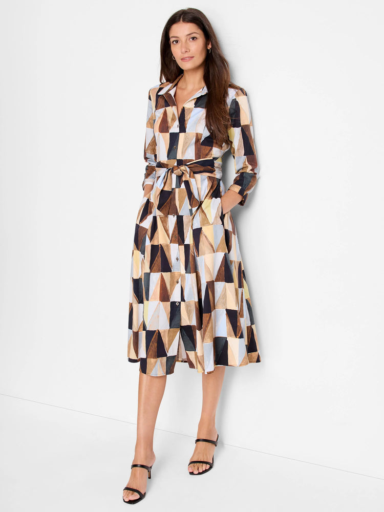 Midi shirt dress, belted, with geometric print in browns, blues, and beige. Three-quarter sleeves, pockets.