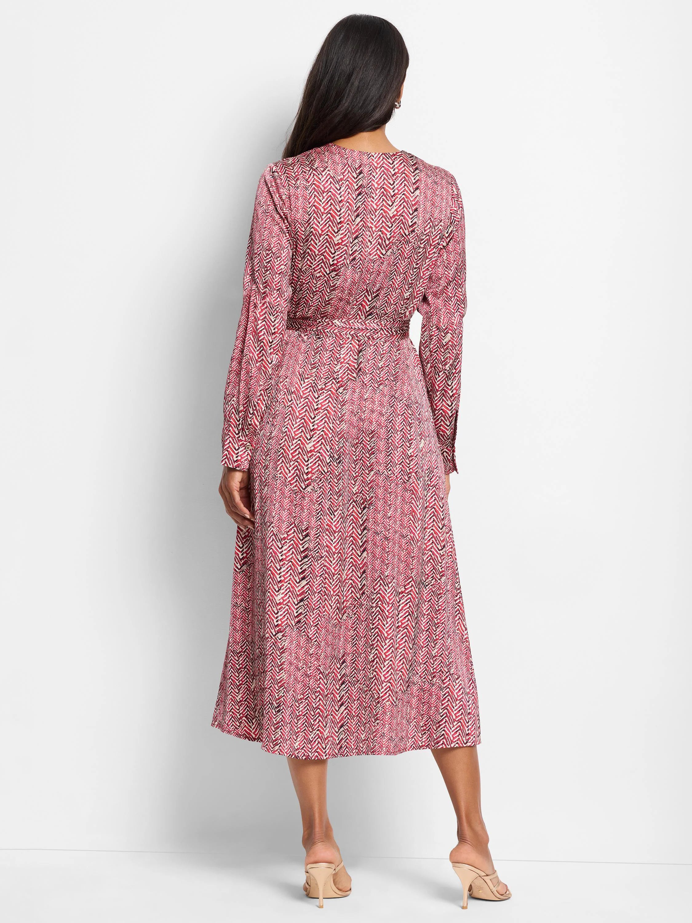 Red midi dress with a herringbone pattern in black and off-white. Long sleeves, belted waist.